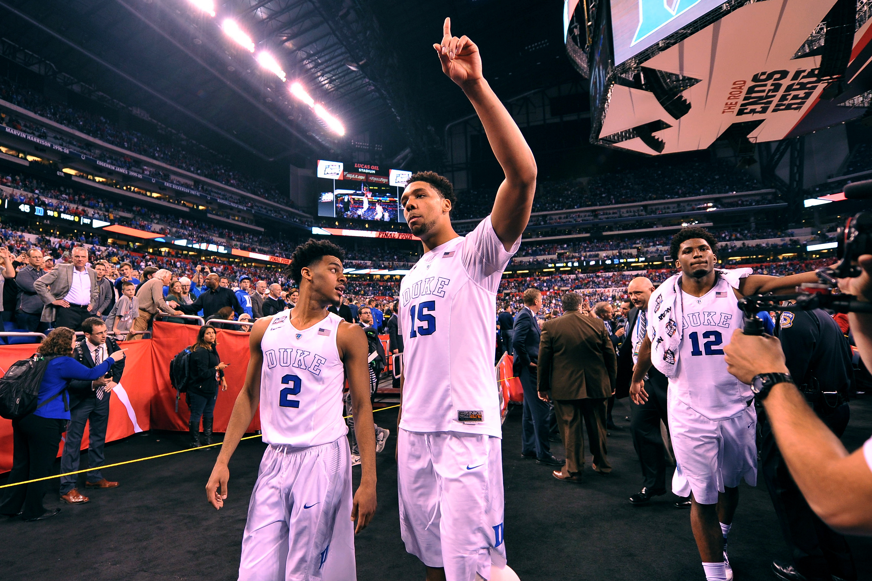 Quinn Cook #2, Jahlil Okafor #15 and Justise Winslow #12 of the Duke Blue Devils acknowledge fans while walking off the court following their 81-61 win against the Michigan State Spartans during the NCAA Men's Final Four Semifinal at Lucas Oil Stadium on