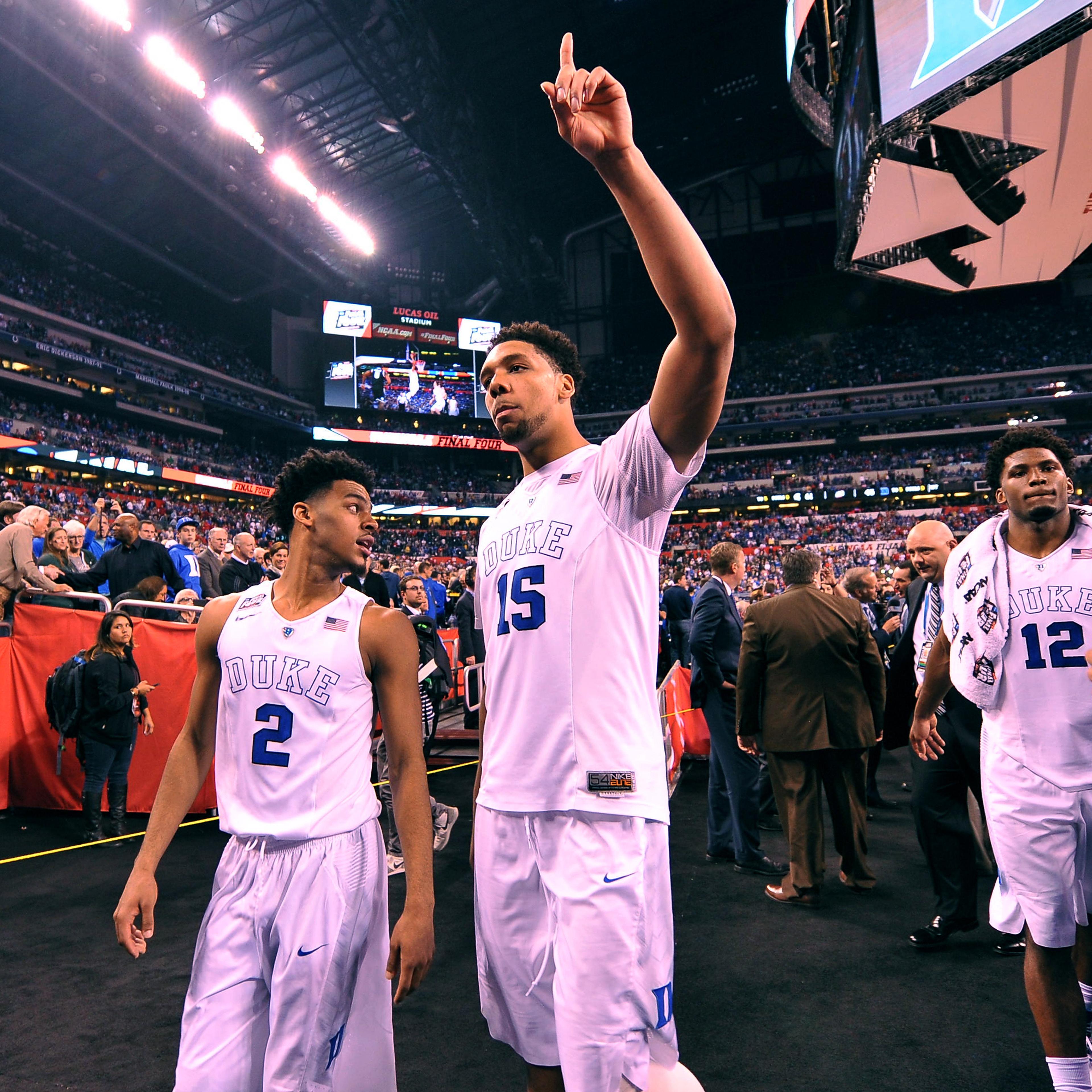 Quinn Cook #2, Jahlil Okafor #15 and Justise Winslow #12 of the Duke Blue Devils acknowledge fans while walking off the court following their 81-61 win against the Michigan State Spartans during the NCAA Men's Final Four Semifinal at Lucas Oil Stadium on