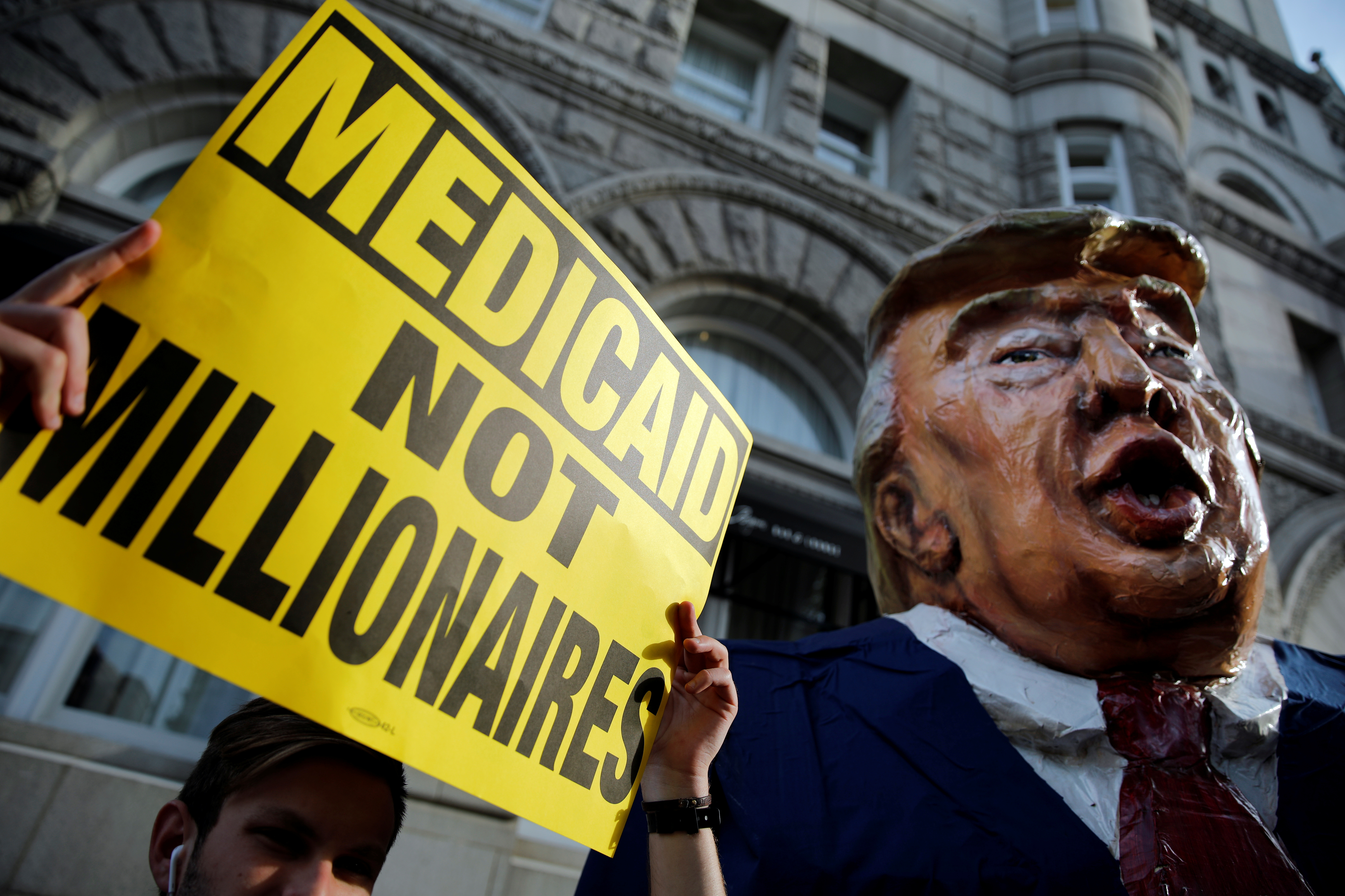 A puppet of U.S. President Trump is seen as protesters gather outside Trump International Hotel in downtown Washington