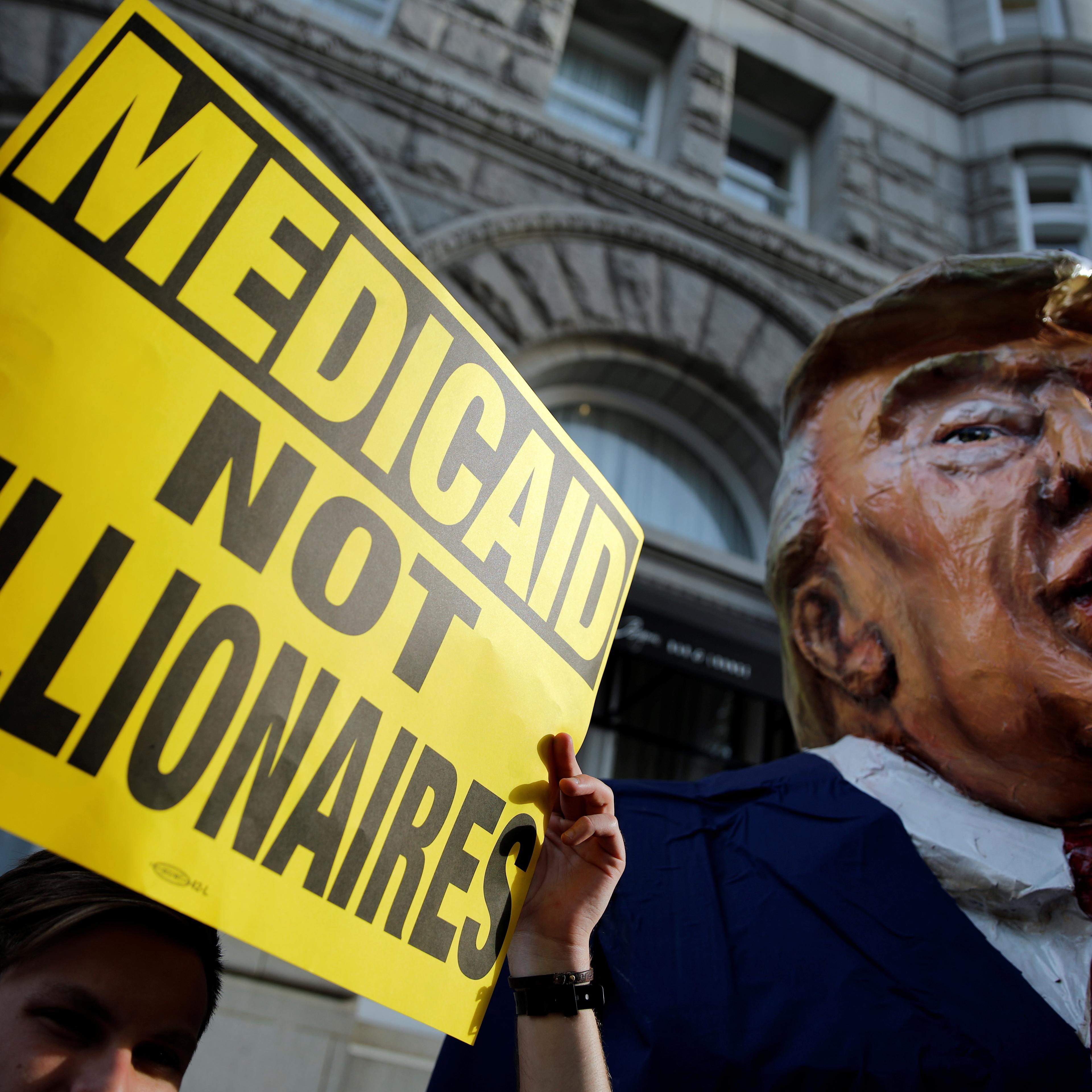 A puppet of U.S. President Trump is seen as protesters gather outside Trump International Hotel in downtown Washington