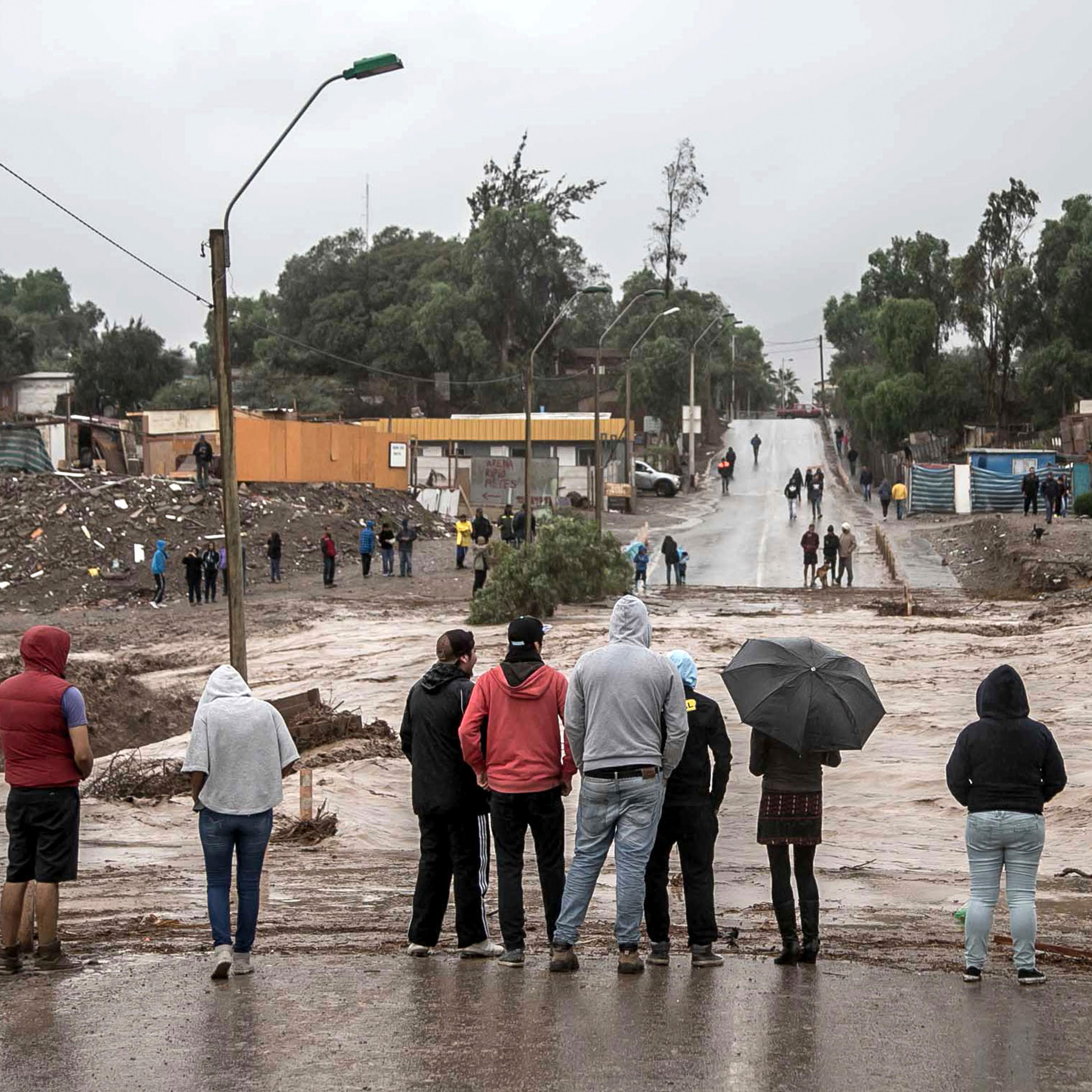 Residents watch the rising flood waters of the Copiapo River, in Copiapo, Chile, March 25, 2015