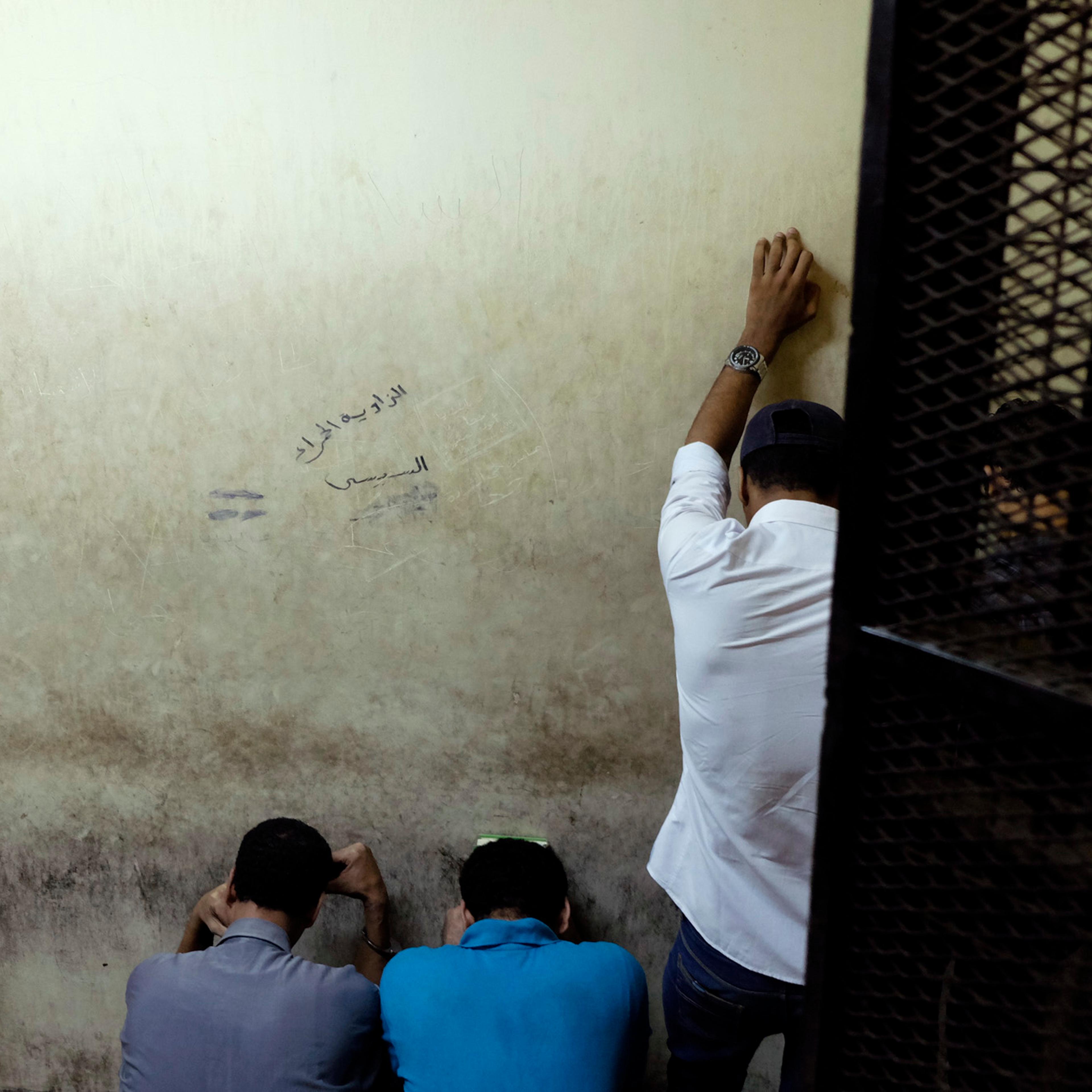 Egyptian men sentenced to life in prison for sexual assaults on women during a number of public rallies in Cairo's iconic Tahrir Square, attend their trial at a court in Cairo, July 16, 2014.