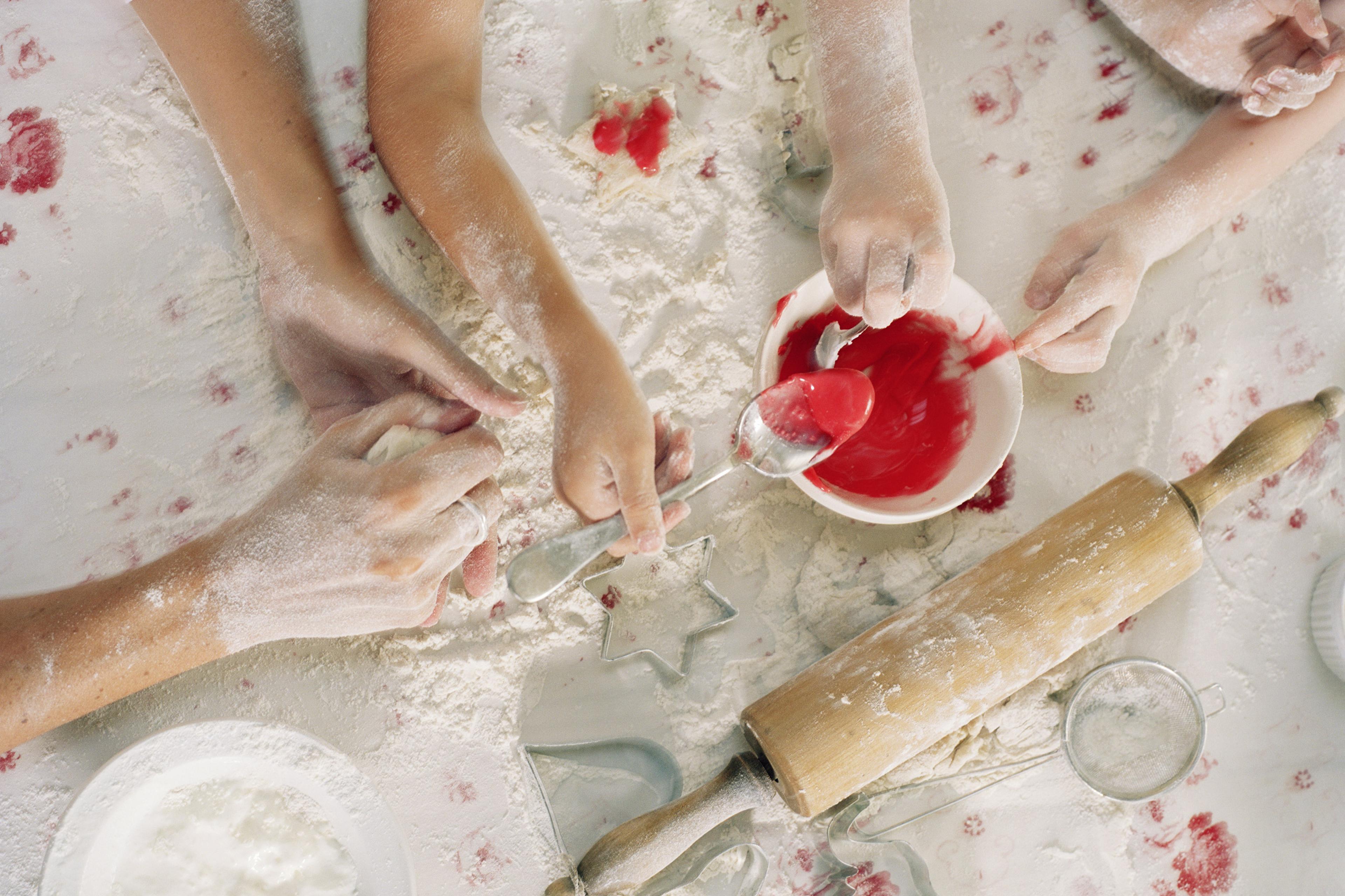 Mother and daughters (4-6) baking, overhead view