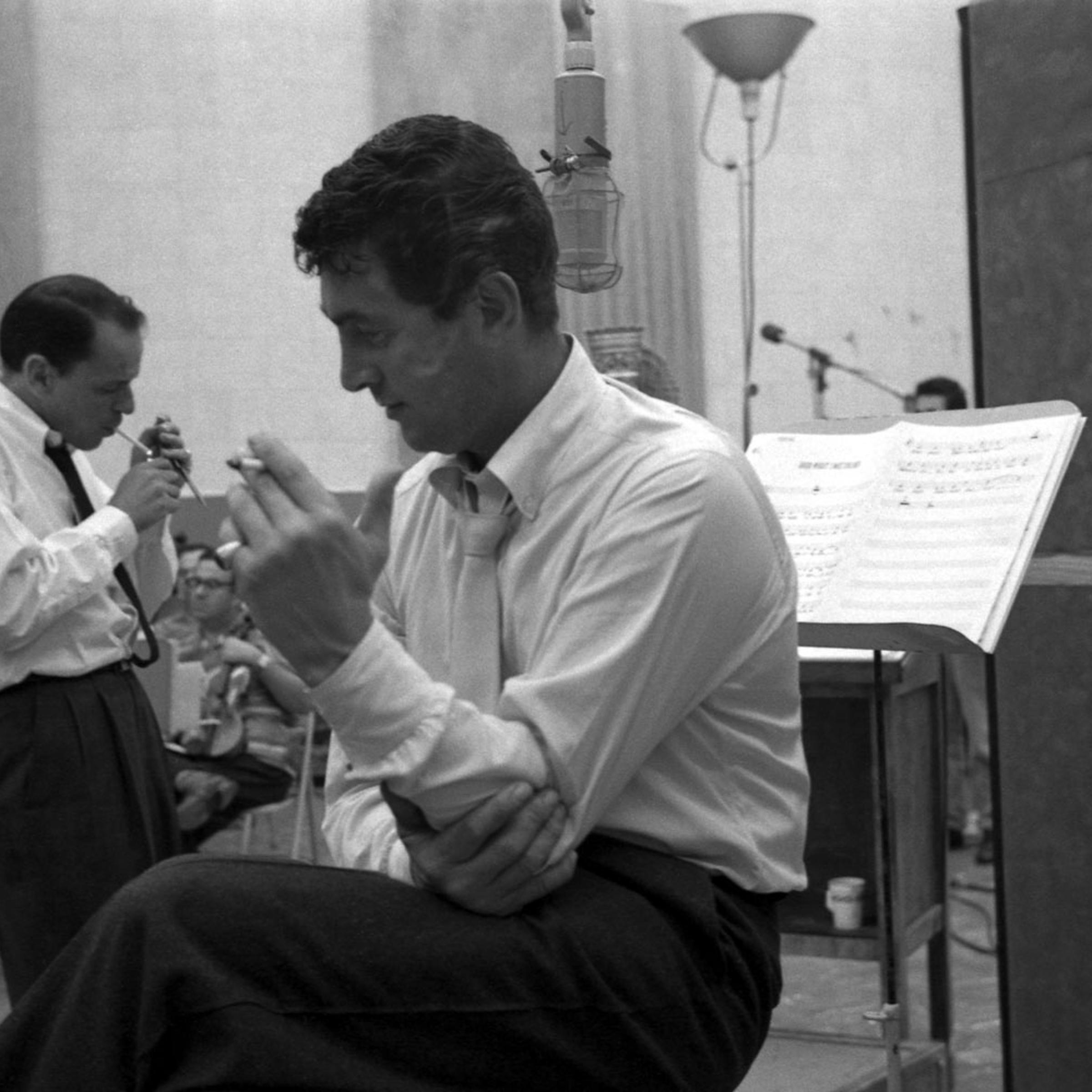 Frank Sinatra and Dean Martin take a cigarette break during the recording of Sleep Warm in 1958.