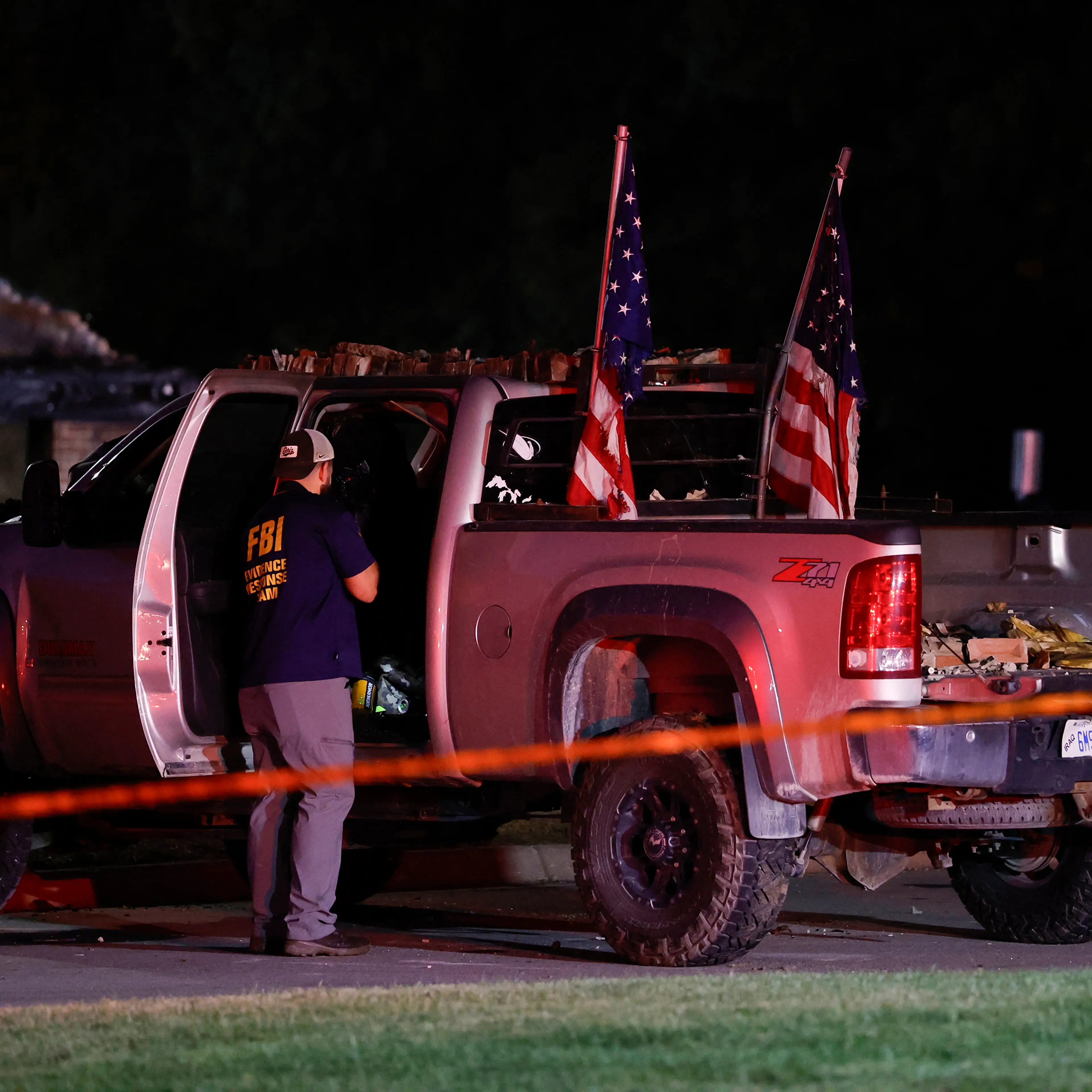An FBI Evidence Response Team agent inspects the suspect's truck outside the Church of Jesus Christ of Latter-day Saints in Grand Blanc, Michigan, on Sept. 28, 2025.