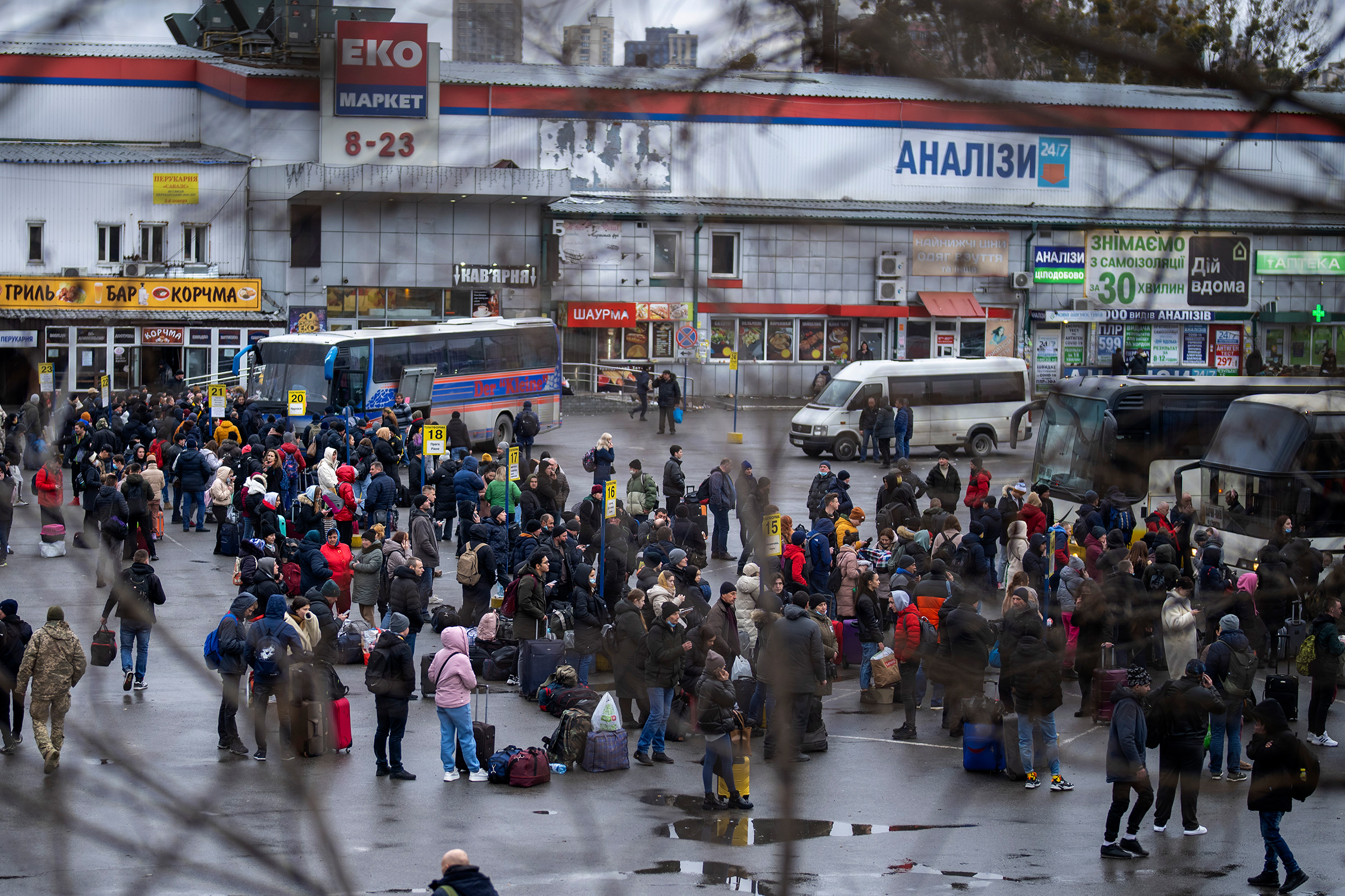 People try to get onto buses to leave Kyiv, Feb. 24