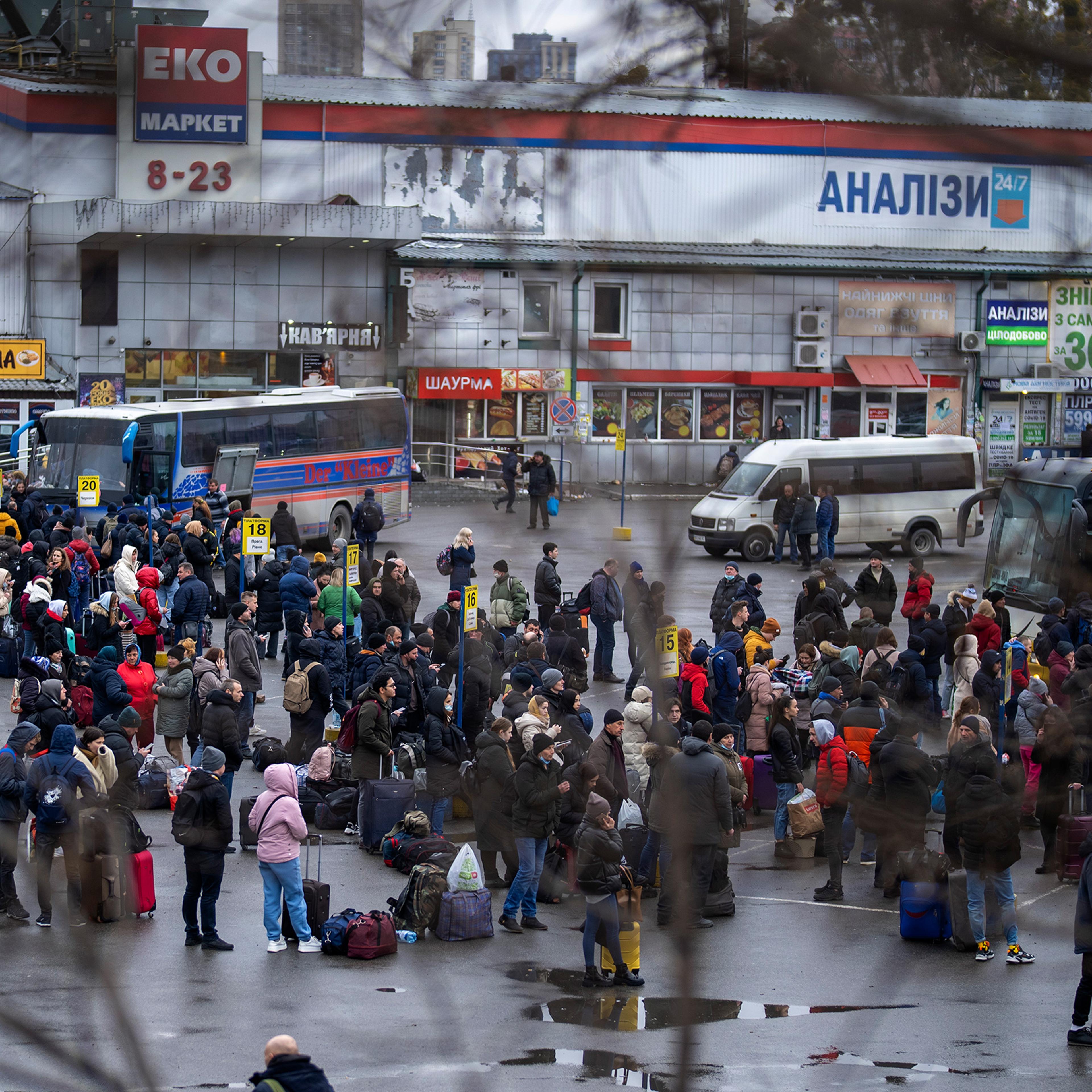 People try to get onto buses to leave Kyiv, Feb. 24