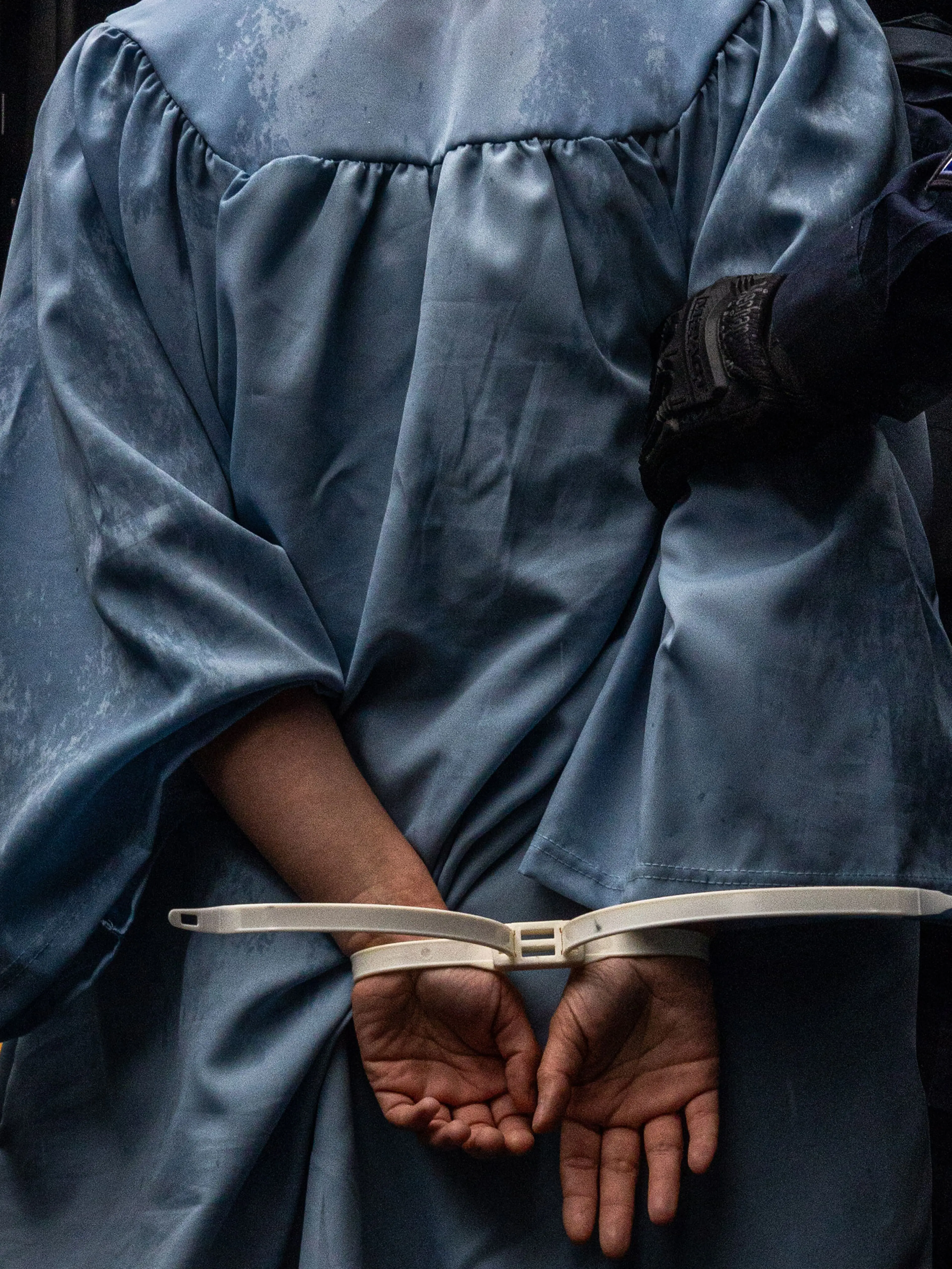 Columbia University alumni Jess Pearce is arrested during a protest of Columbia University outside the campus during their graduation ceremony in New York, NY on Wednesday, May 21, 2025. (Alex Kent/The New York Times)