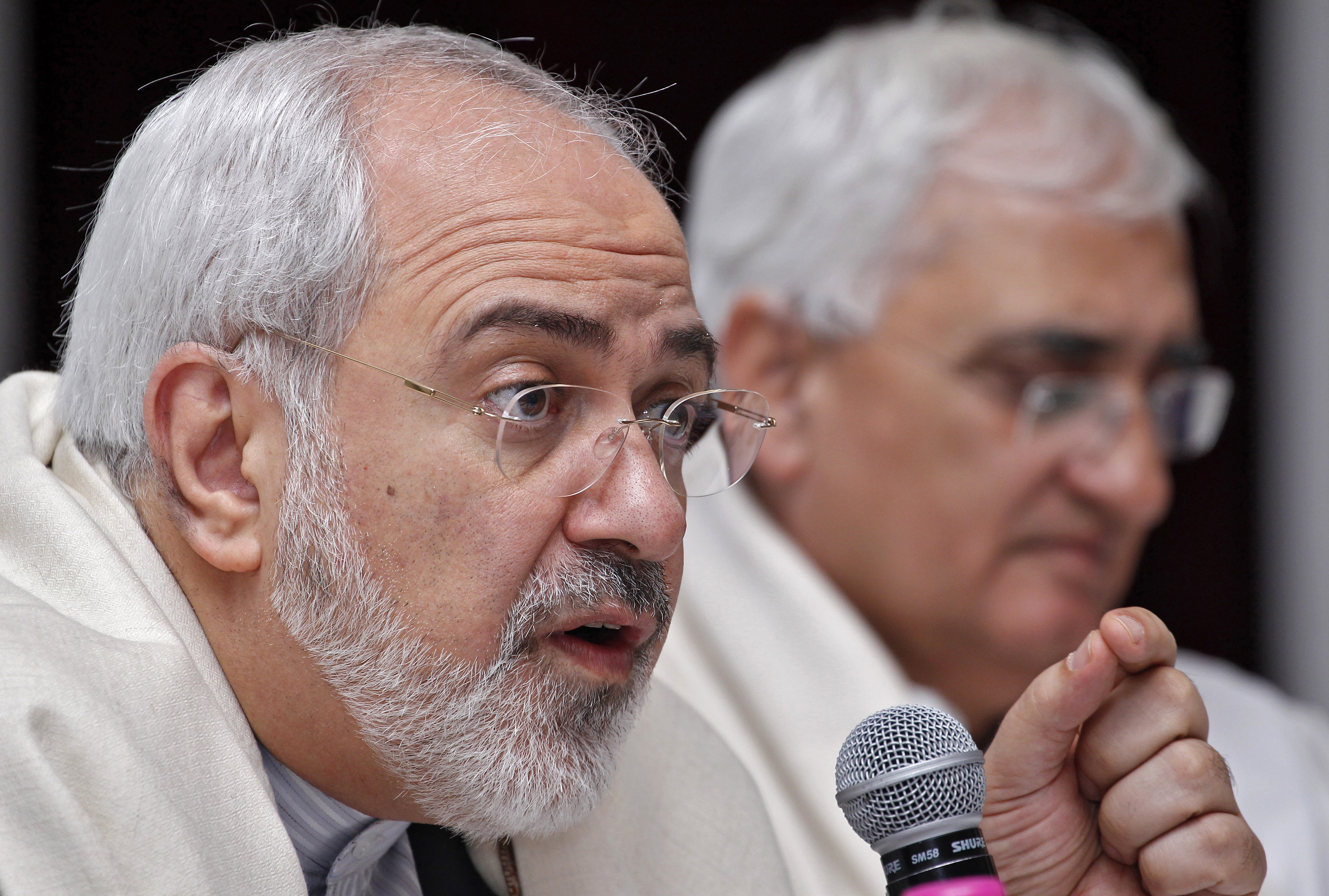 Iran's Foreign Minister Mohammad Javad Zarif speaks as his Indian counterpart Salman Khurshid watches during a lecture themed "Iran's Foreign Policy - Towards Stability in West Asia" organized by the Observer Research Foundation in New Delhi on February 