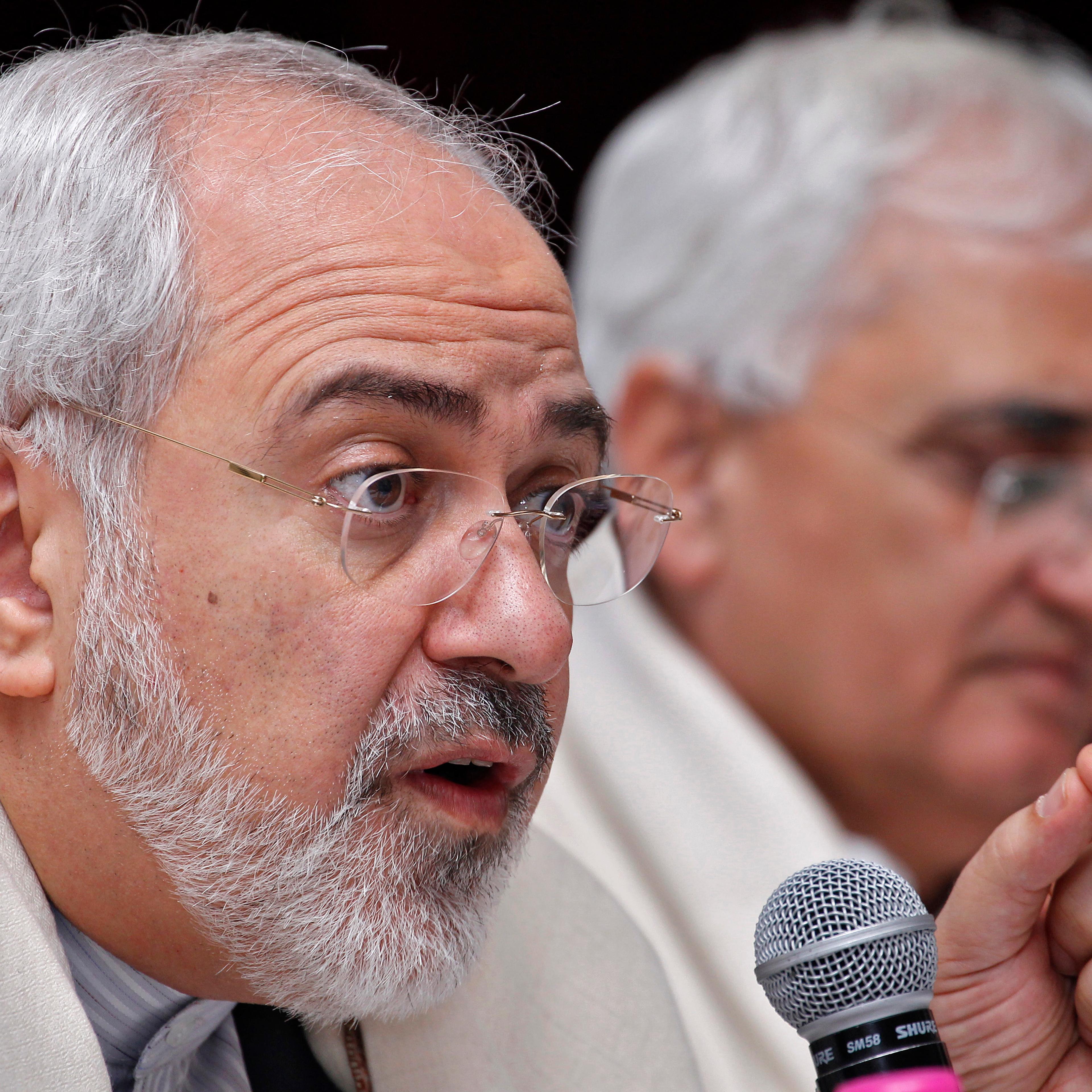 Iran's Foreign Minister Mohammad Javad Zarif speaks as his Indian counterpart Salman Khurshid watches during a lecture themed "Iran's Foreign Policy - Towards Stability in West Asia" organized by the Observer Research Foundation in New Delhi on February