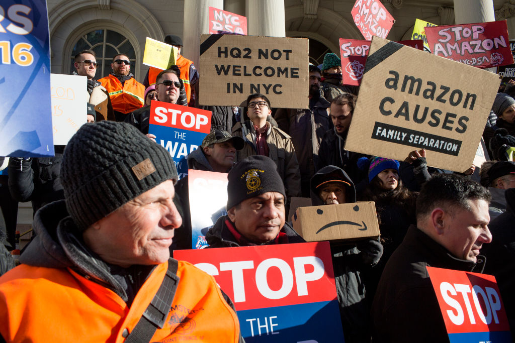 Protestors stand outside New York city council about Amazon
