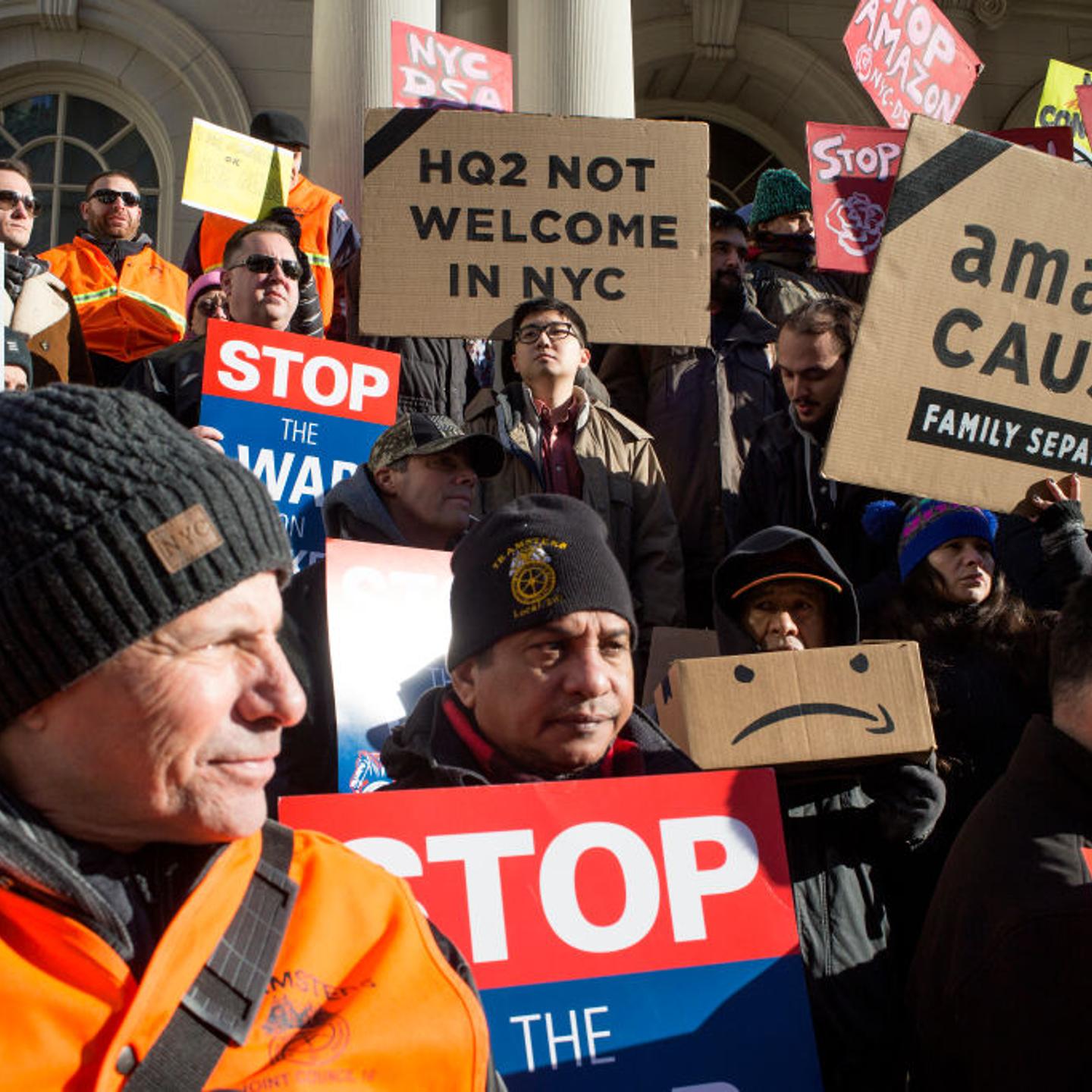 Protestors stand outside New York city council about Amazon