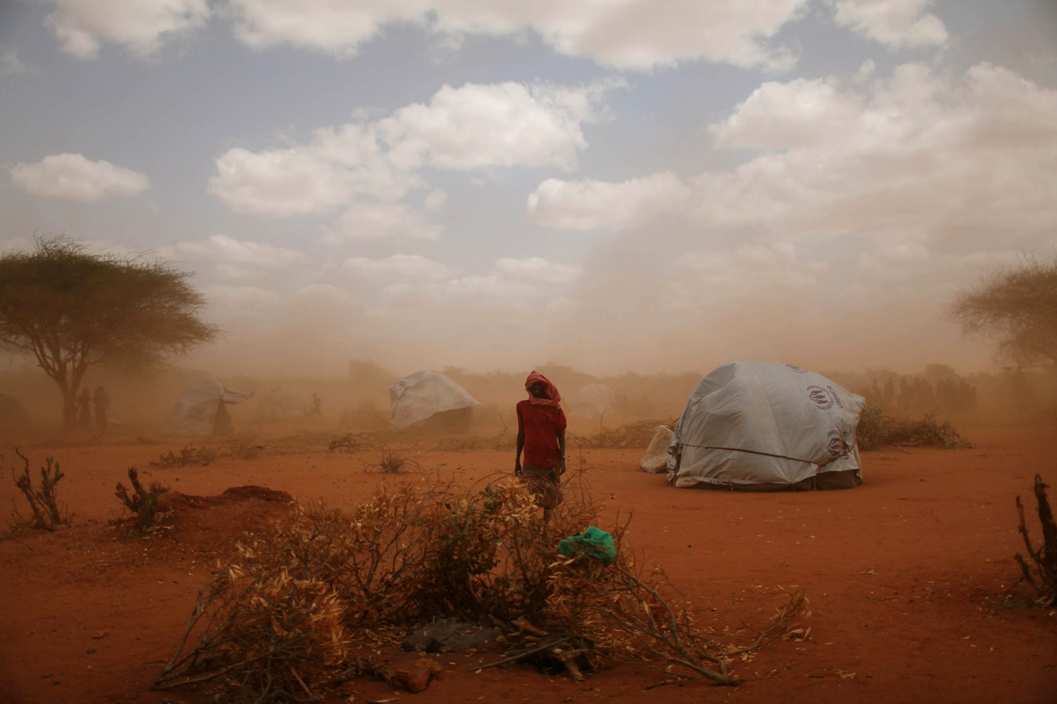 A sandstorm blows through Ifo Camp where new arrivals live. 30,000 people are estimated to have arrived at the camp in June, a steep climb from the average of 5,000 last year. Dadaab, Eastern Kenya, July 18, 2011.