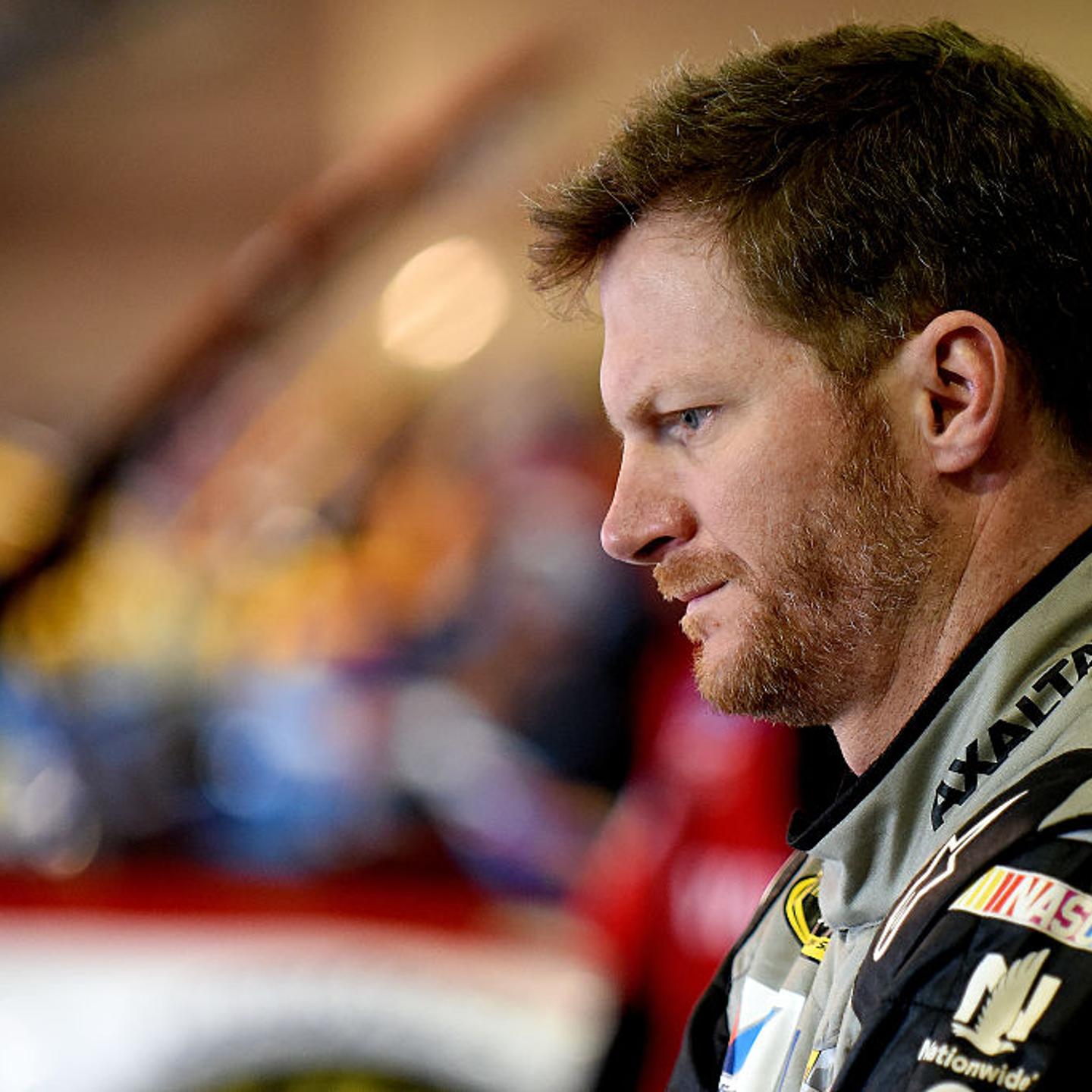Dale Earnhardt Jr. stands in the garage area during practice for the NASCAR Sprint Cup Series Auto Club 400 at Auto Club Speedway on March 19, 2016 in Fontana, California.
