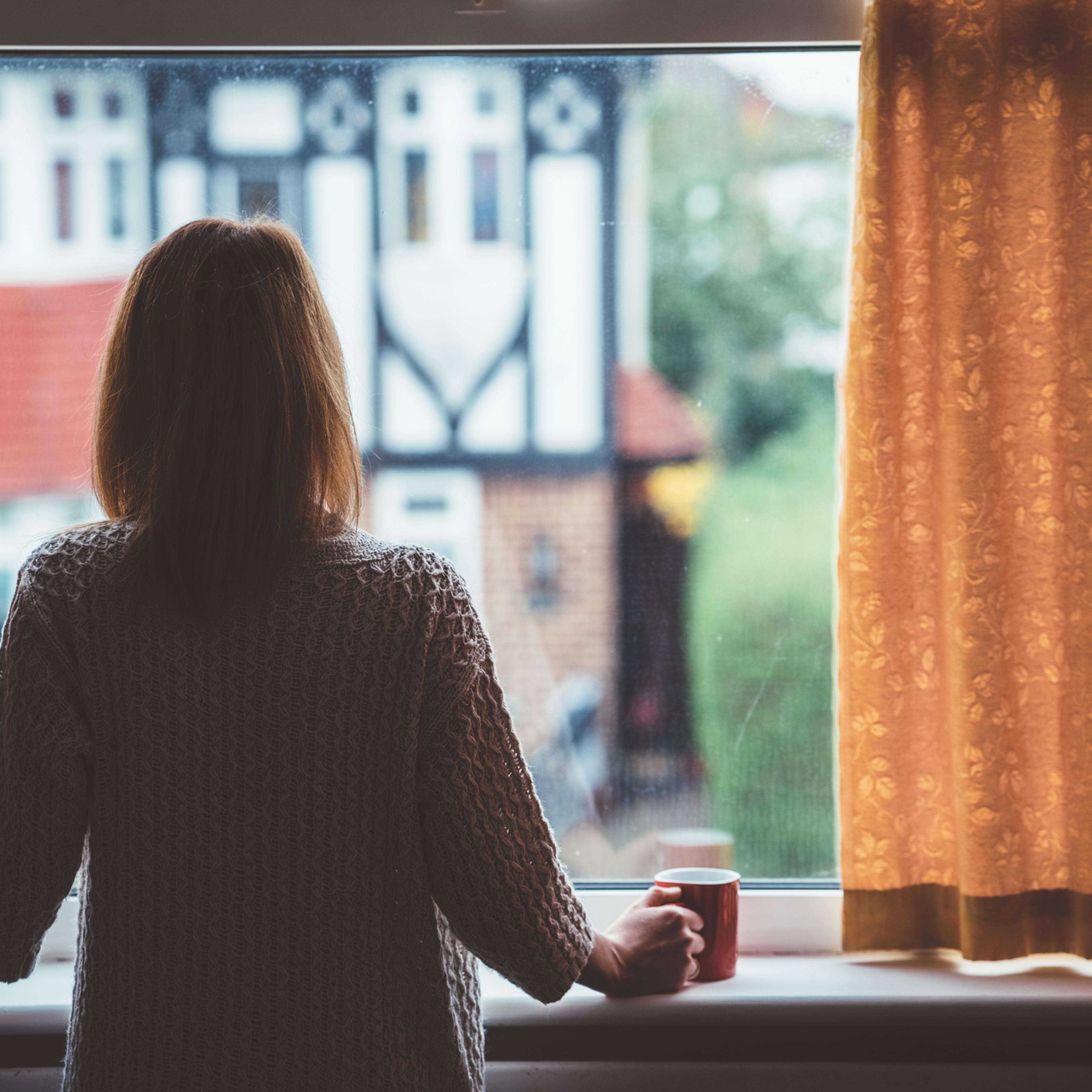 Woman drinking tea at home