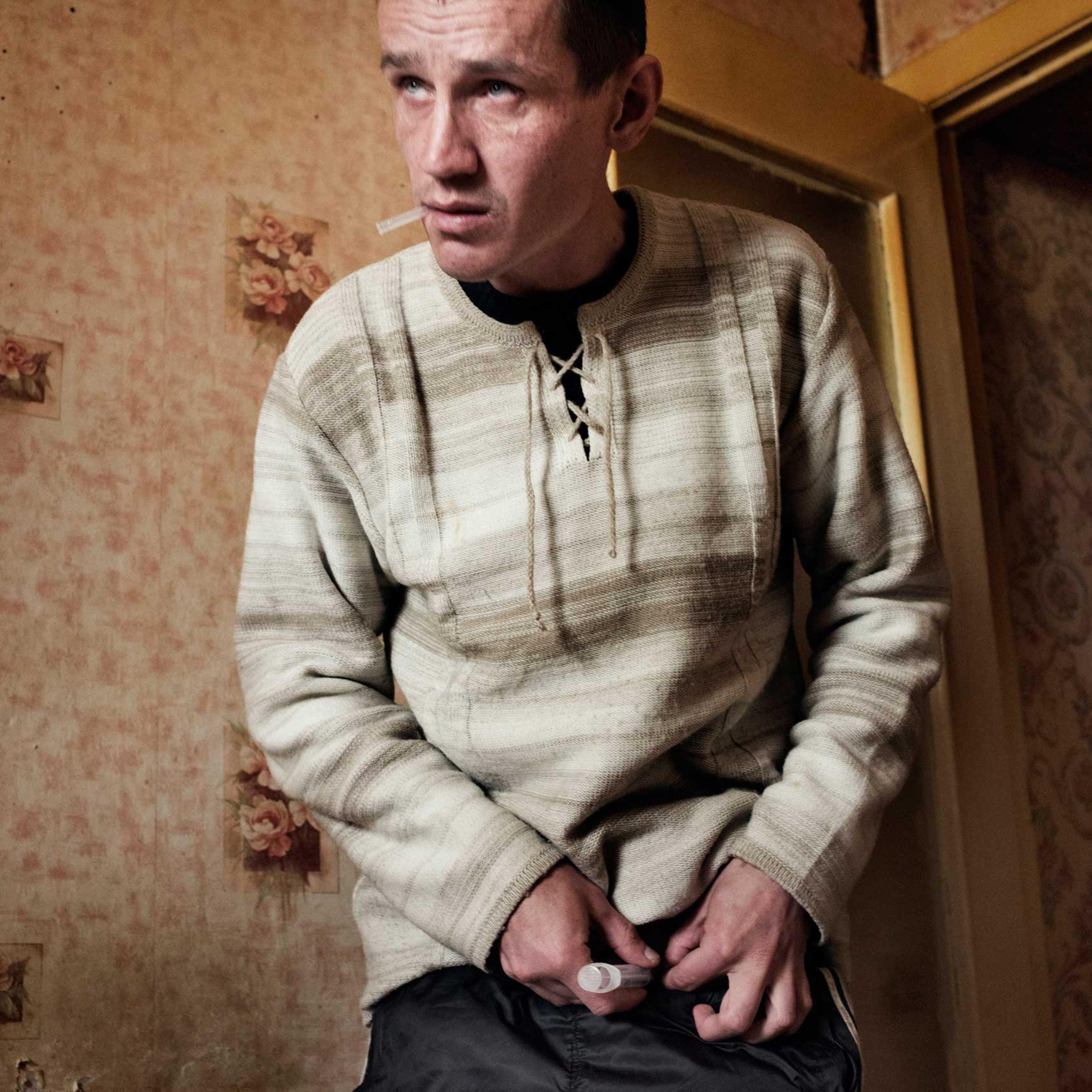 The following photographs were taken in Yekaterinburg, Russia in 2013.Alexei, age 33, injects a dose of krokodil. Because of his dependence on krokodil, Alexei has injuries and swelling around his feet and is forced to walk with a cane.