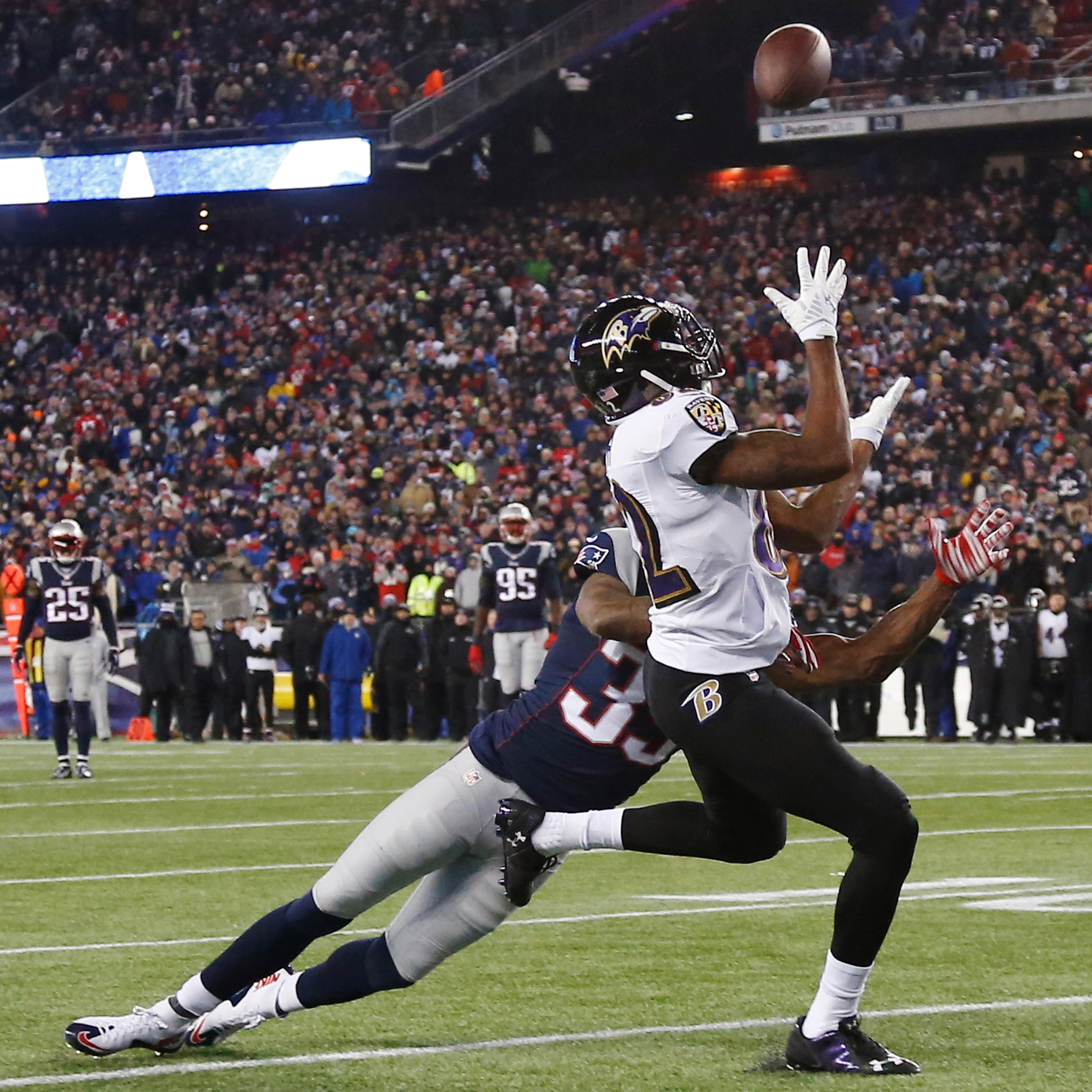Baltimore Ravens wide receiver Torrey Smith (82) catches a pass in front of New England Patriots cornerback Brandon Browner (39) in the second half of an NFL divisional playoff football game Saturday, Jan. 10, 2015, in Foxborough, Mass.