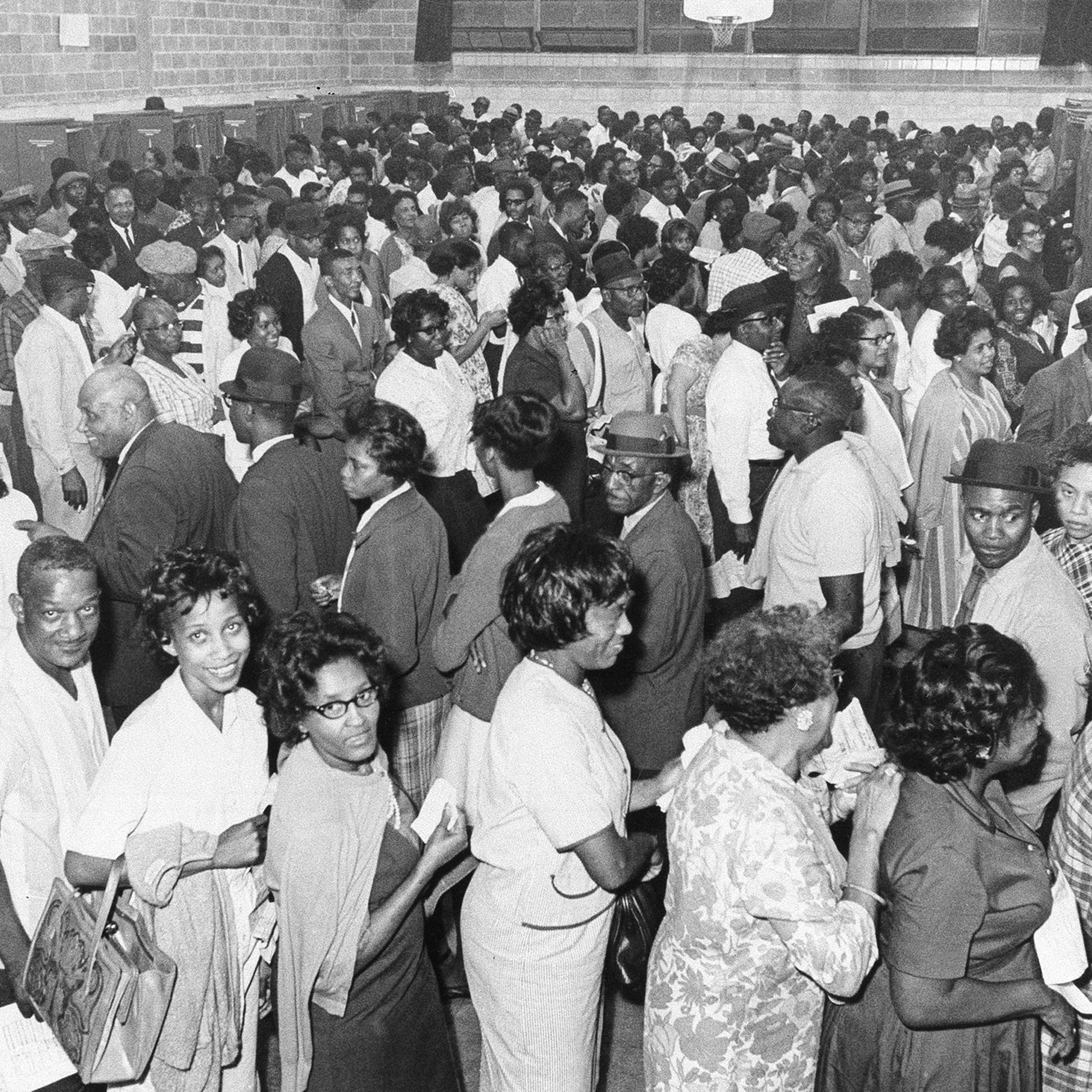 African Americans line up to vote after the passage of the Voting Rights Act in 1965