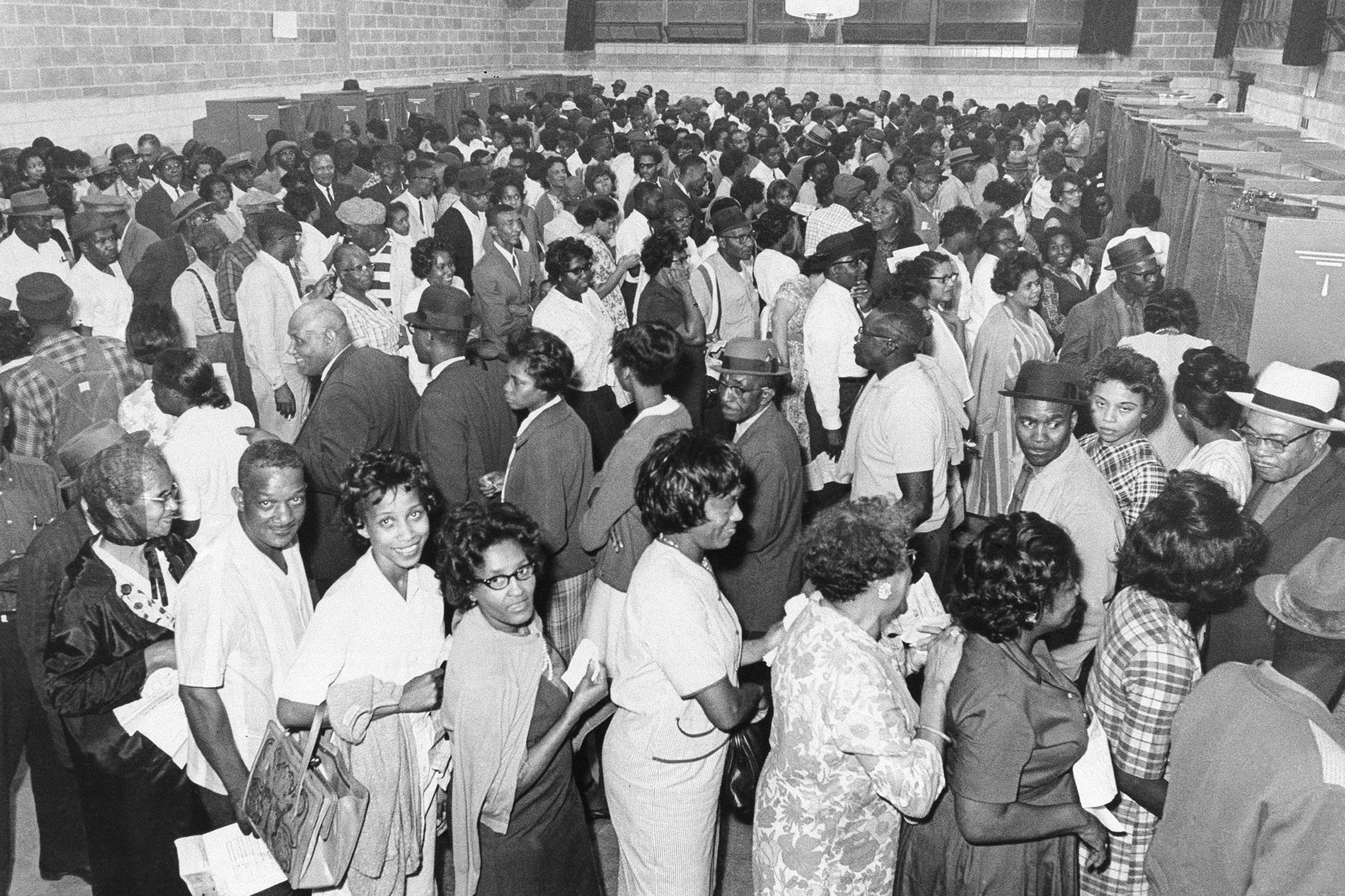 African Americans line up to vote after the passage of the Voting Rights Act in 1965