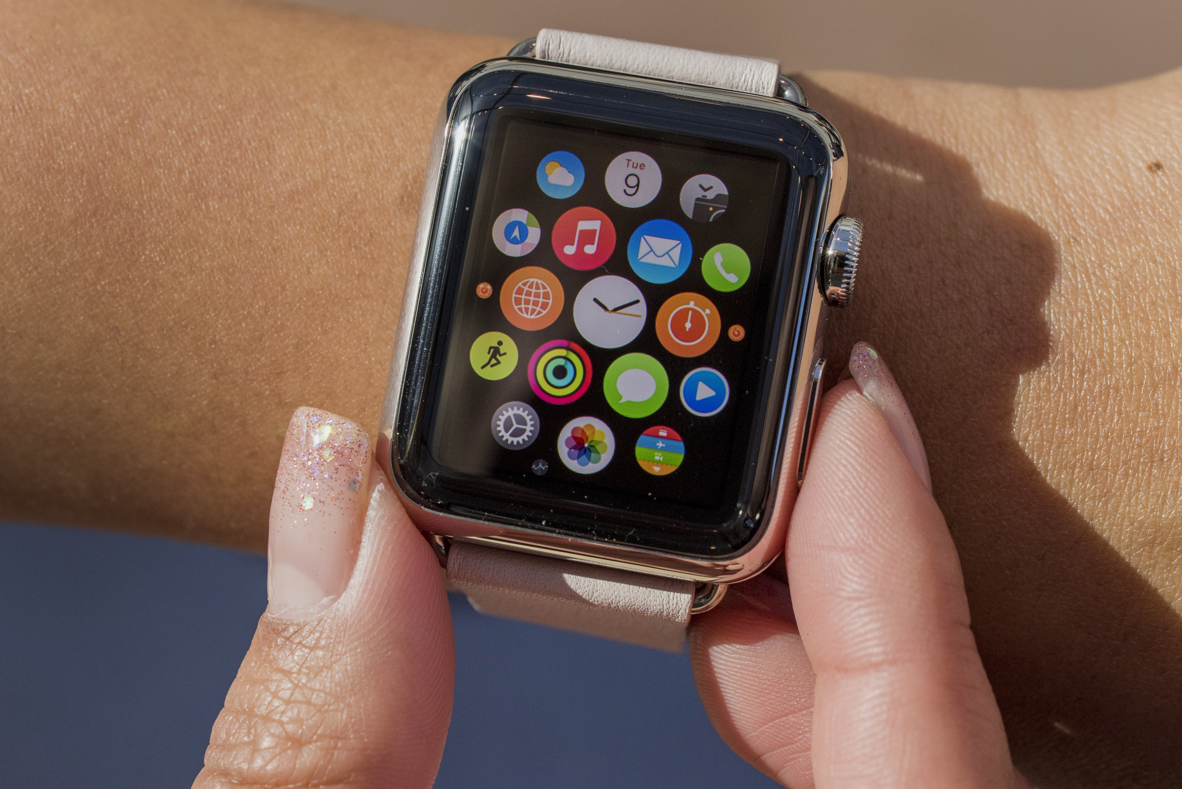 Customers look at Apple Watches on display at an Apple Inc. store in Palo Alto, California, U.S., on Friday, April 10, 2015. From London to Beijing, Apple stores saw few customers lined up before opening Friday as pre-orders started. The first new gadget