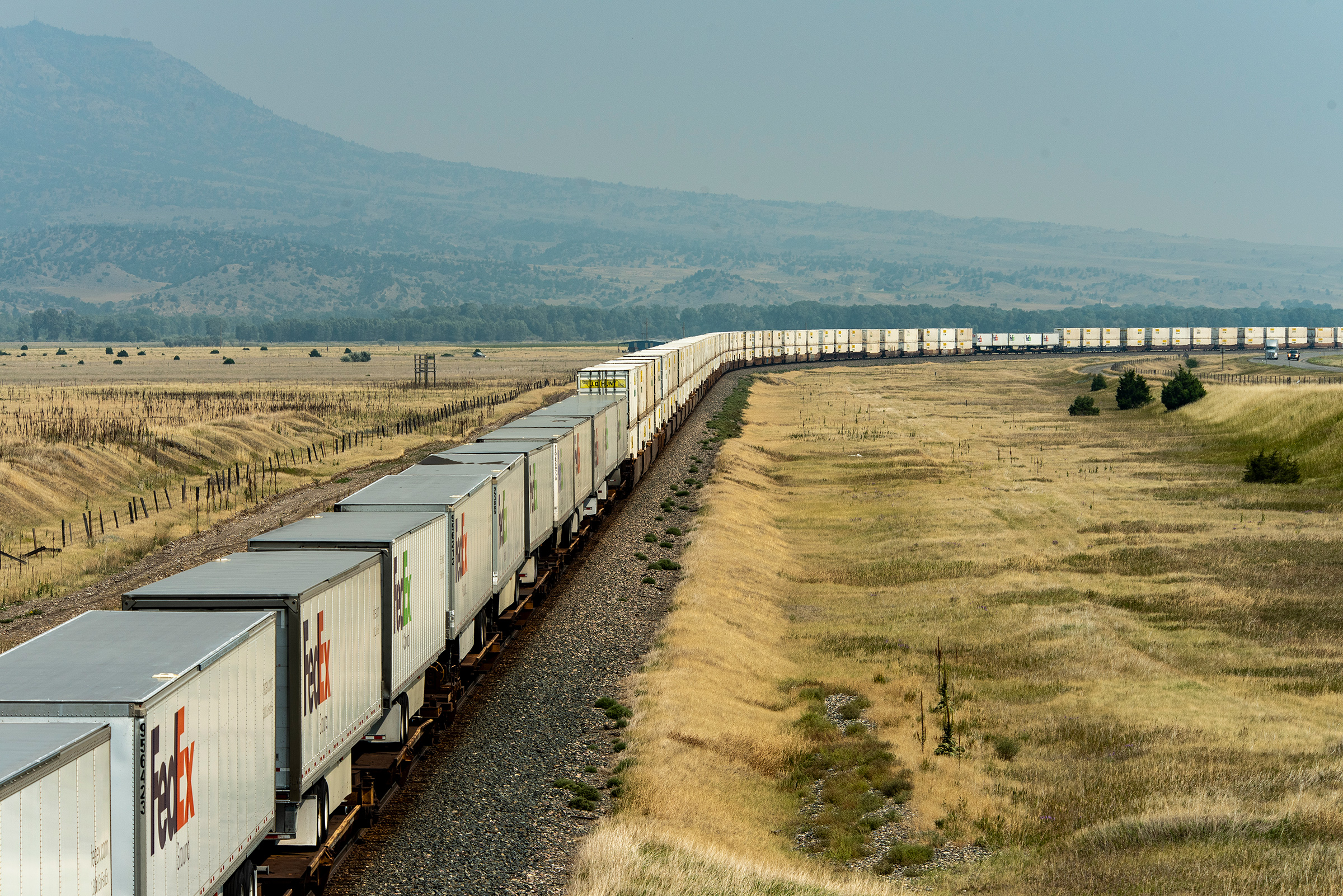 A BNSF freight train with 76 container cars and FedEx freight trailers travels from Seattle to points east on August 23, 2021 in Livingston, Mont.