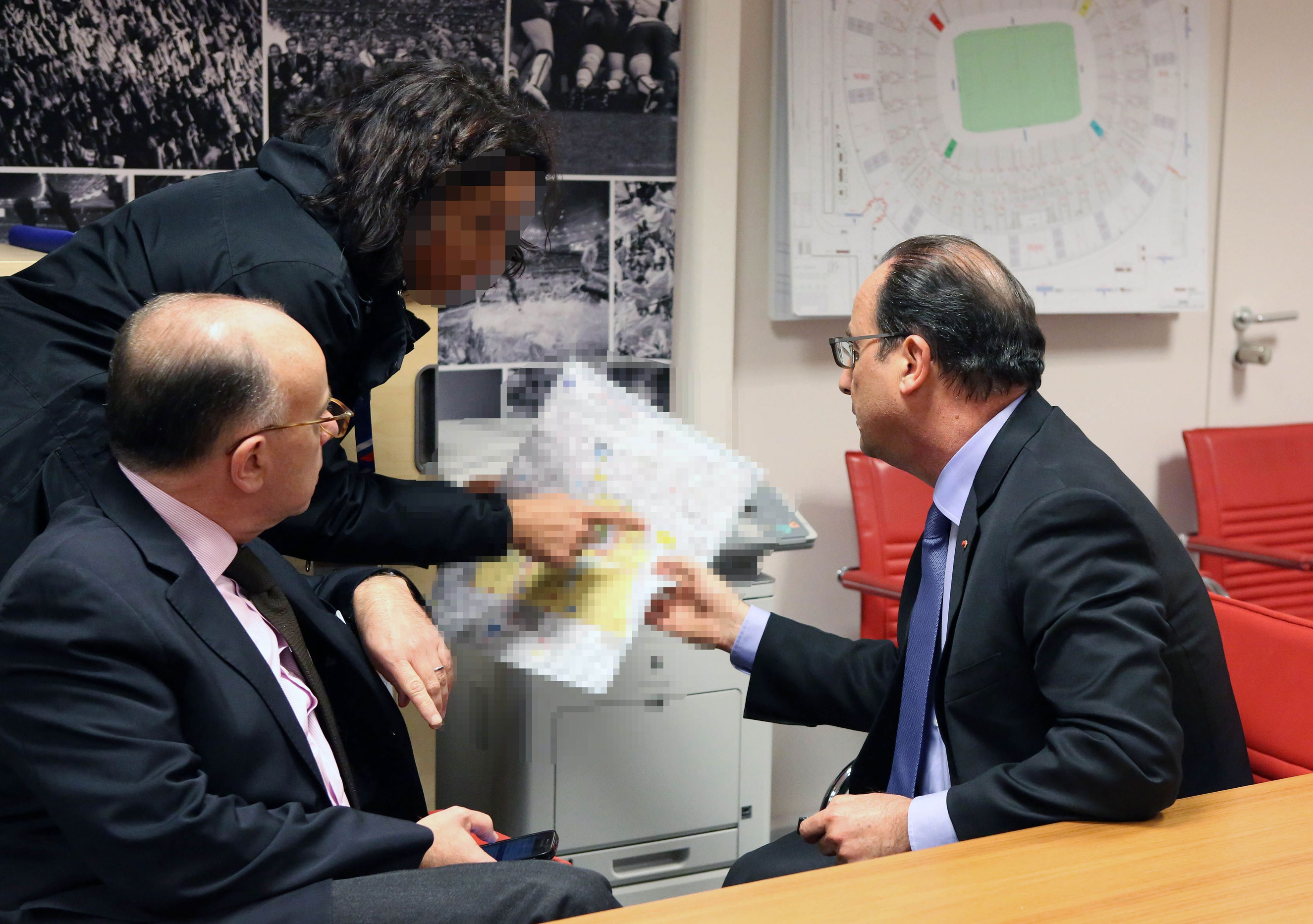 French Interior Minister Bernard Cazeneuve (left) and French President Francois Hollande during an emergency meeting in the security control room at the Stade de France stadium in Saint-Denis, near Paris, on Nov. 13, 2015.