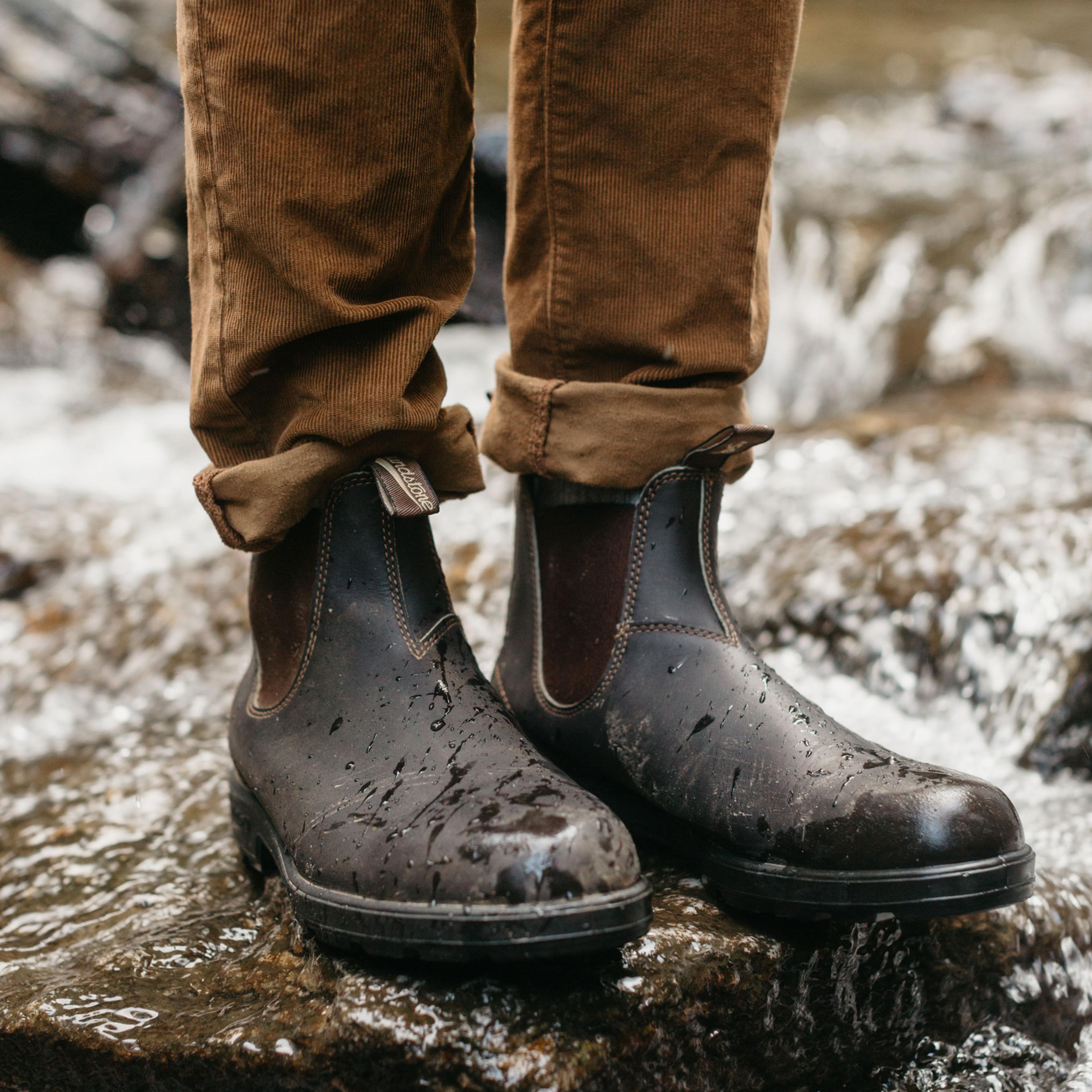 a person wearing Blundstone boots