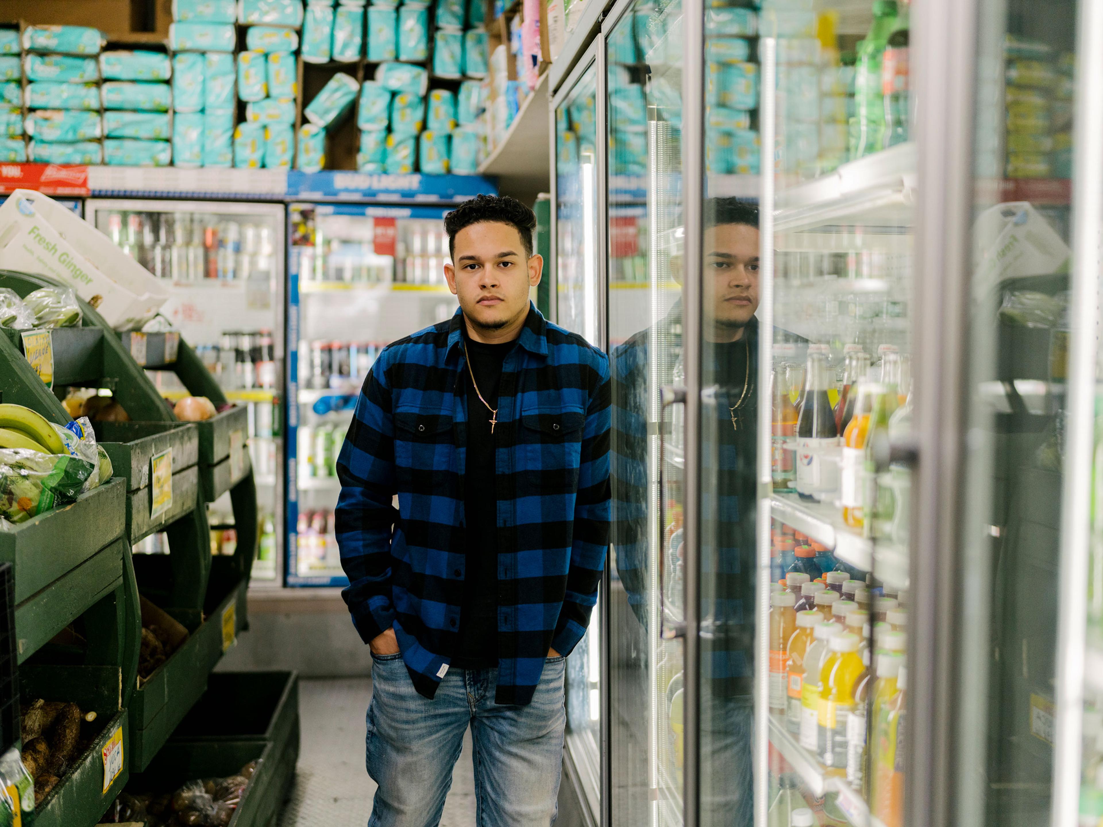 Jason Vargas, who hopes of join the NYPD, poses for a portrait at his father’s deli in the Bronx.