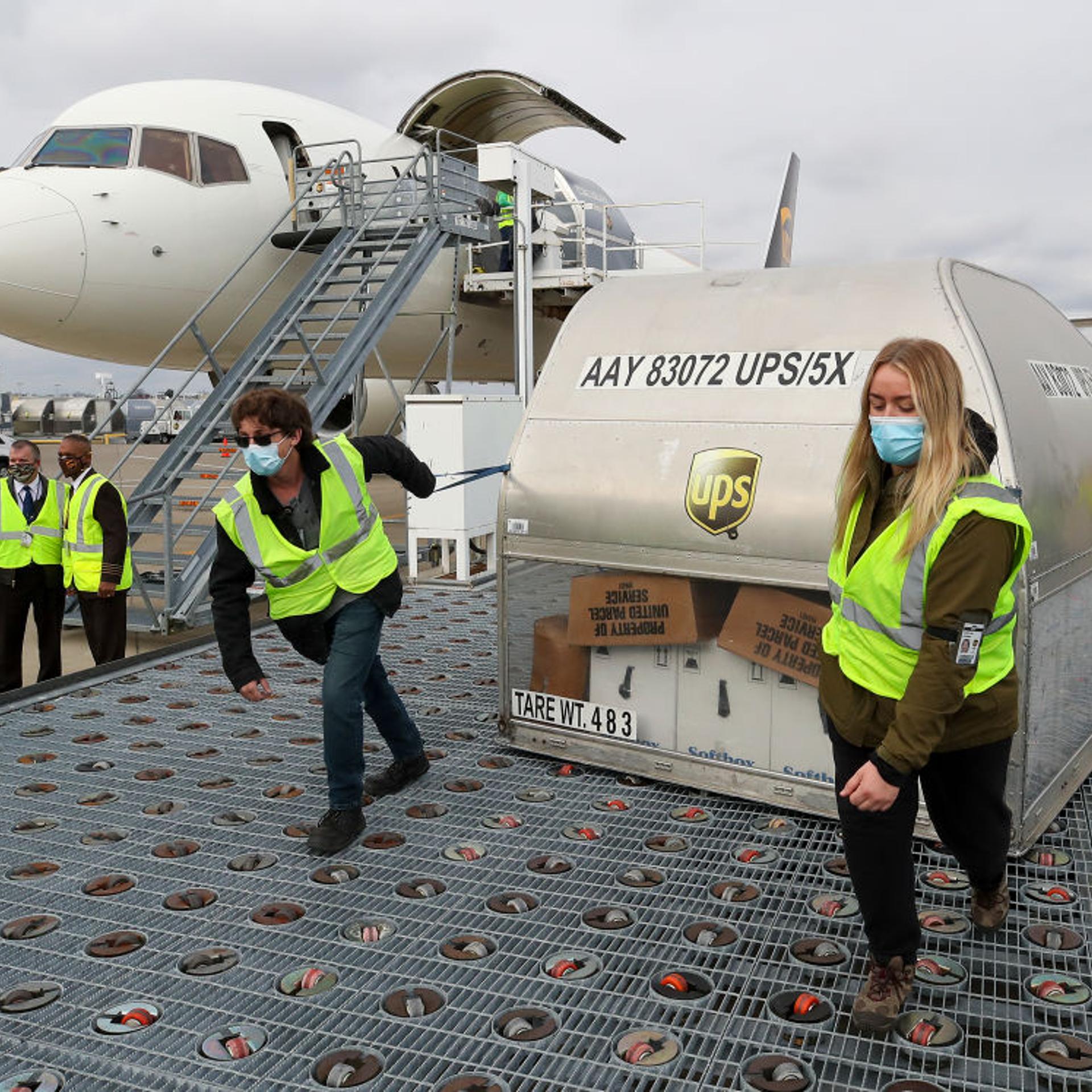 UPS employees move first shipping containers of the Pfizer-BioNTech COVID-19 vaccine in Louisville, Ky. on Dec. 13.