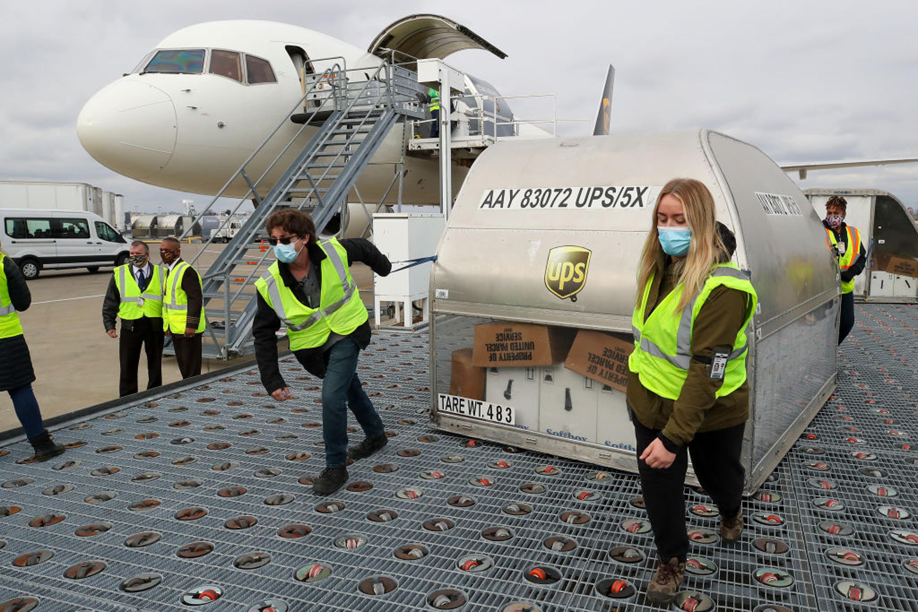 UPS employees move first shipping containers of the Pfizer-BioNTech COVID-19 vaccine in Louisville, Ky. on Dec. 13.