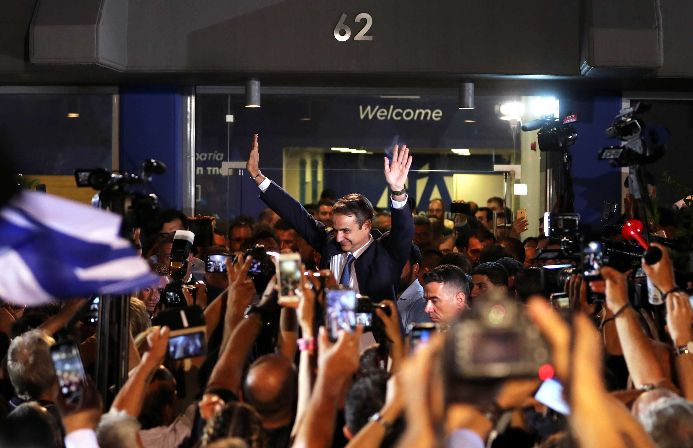 Newly-elected Prime Minister Kyriakos Mitsotakis waves as he speaks outside the New Democracy party headquarters after winning the general election on July 7 in Athens, Greece.