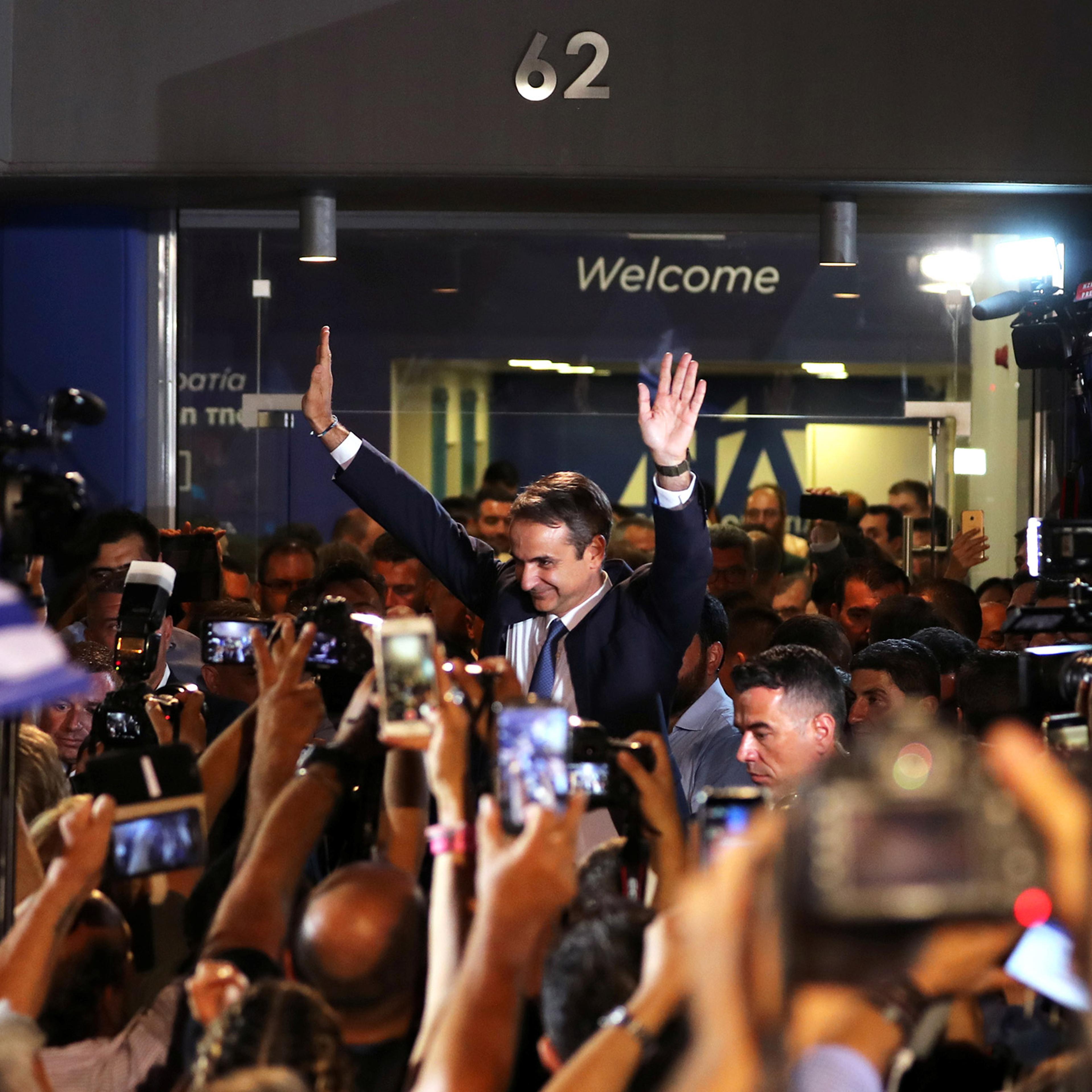 Newly-elected Prime Minister Kyriakos Mitsotakis waves as he speaks outside the New Democracy party headquarters after winning the general election on July 7 in Athens, Greece.