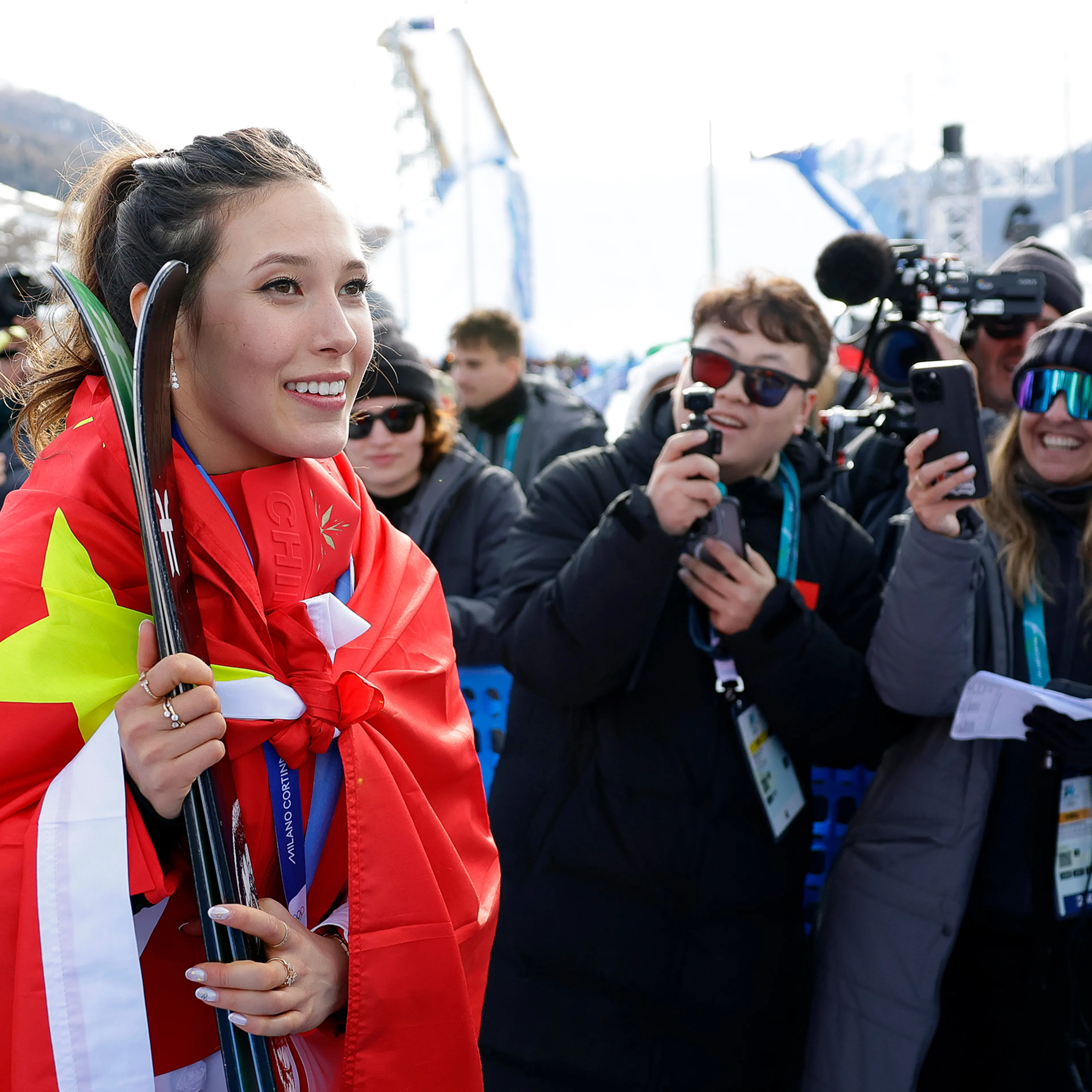 Silver medalist China's Eileen Gu talks with friends and family after the women's freestyle skiing slopestyle finals at the 2026 Winter Olympics, in Livigno, Italy on Feb. 9, 2026.