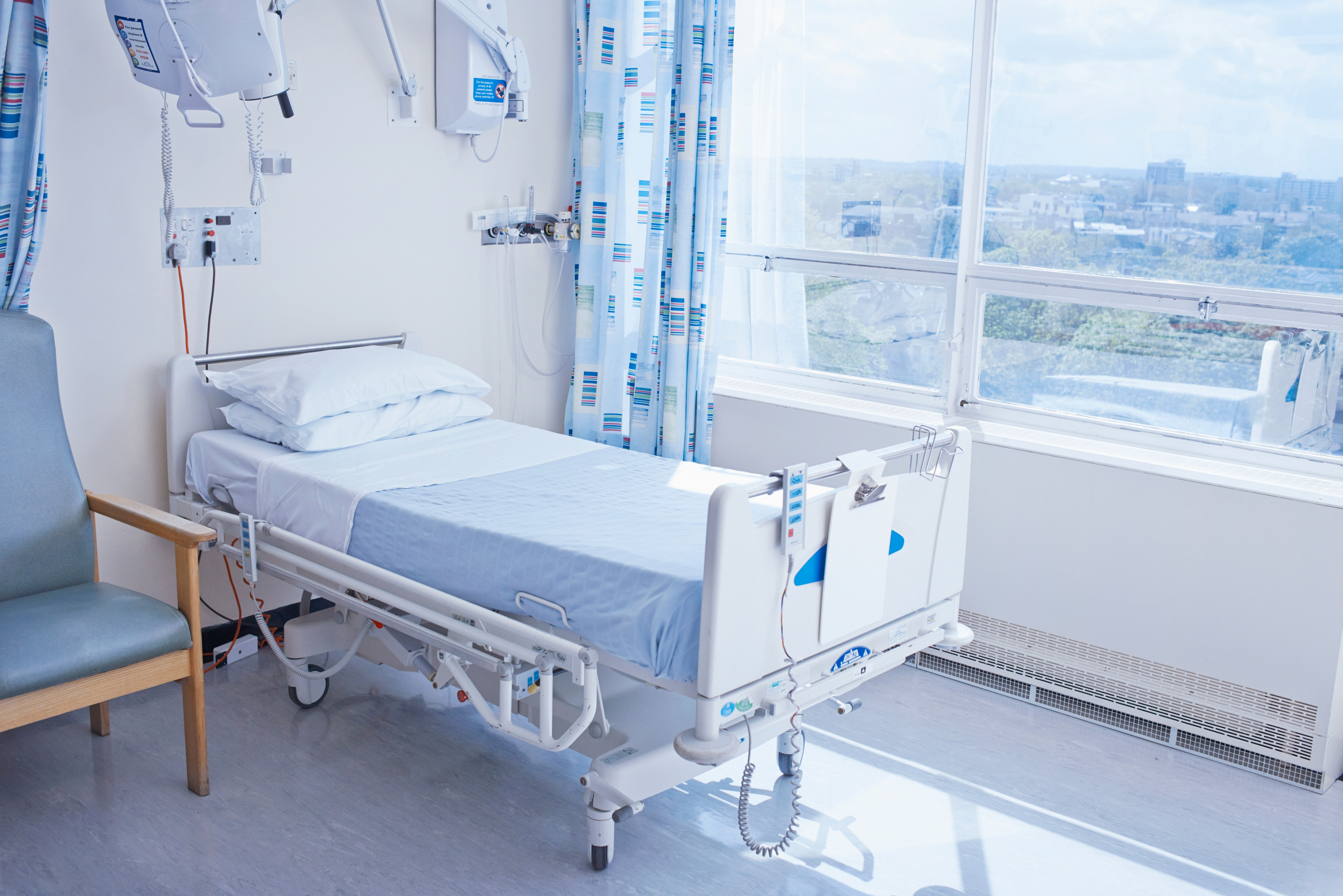 Empty hospital bed on hospital ward