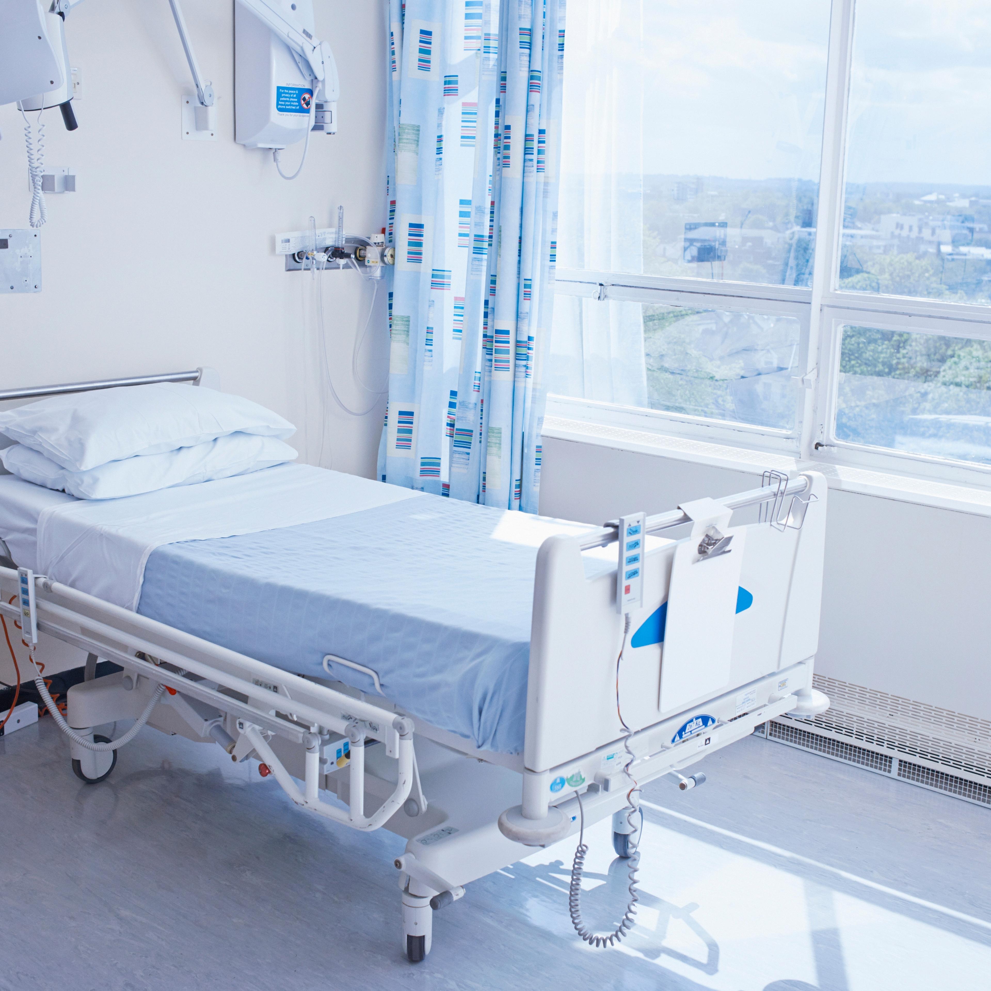 Empty hospital bed on hospital ward