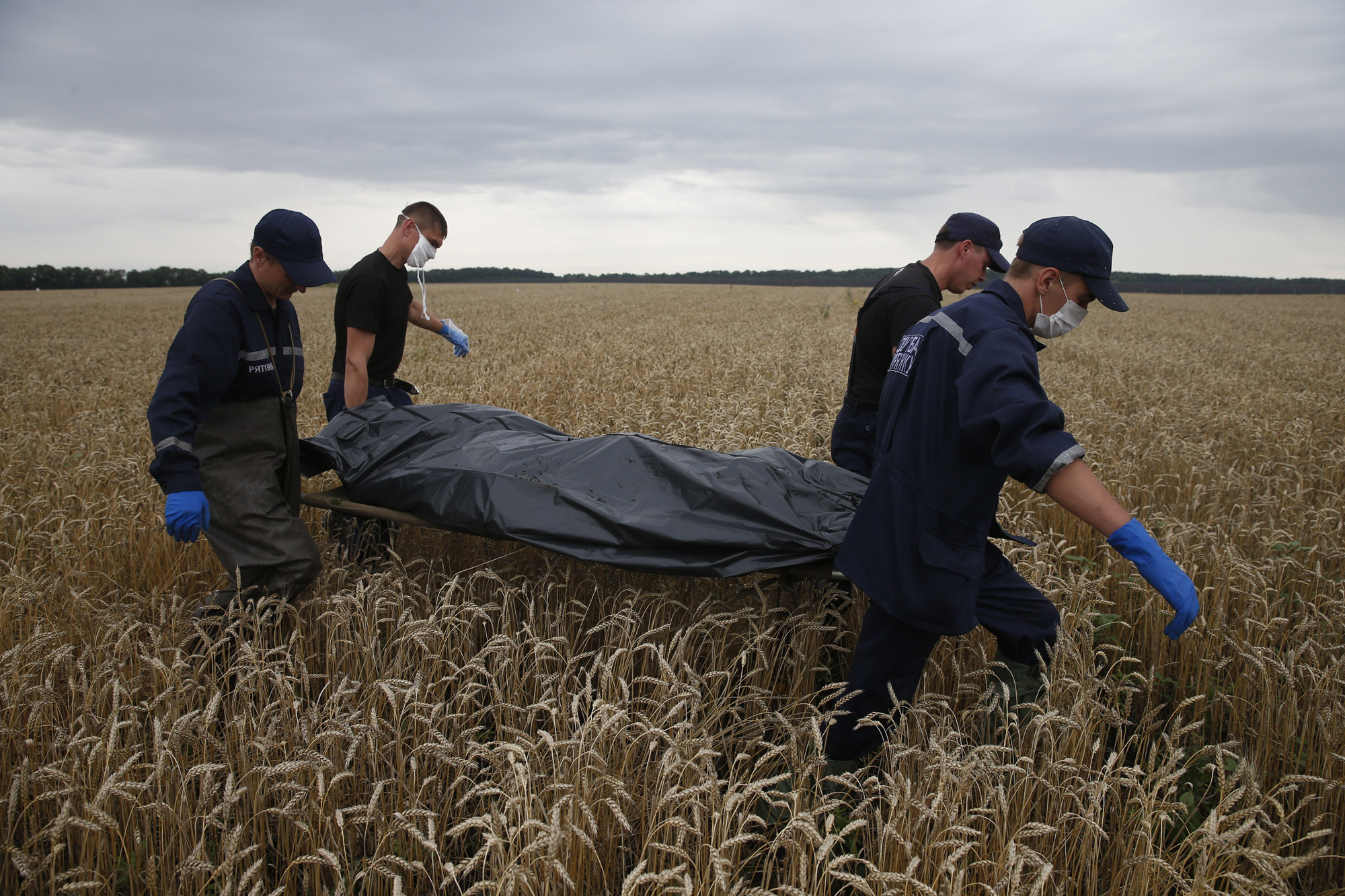 Emergency Workers carry a body at the crash site of Malaysia Airlines Flight MH17, near the settlement of Grabovo in the Donetsk region July 19, 2014.