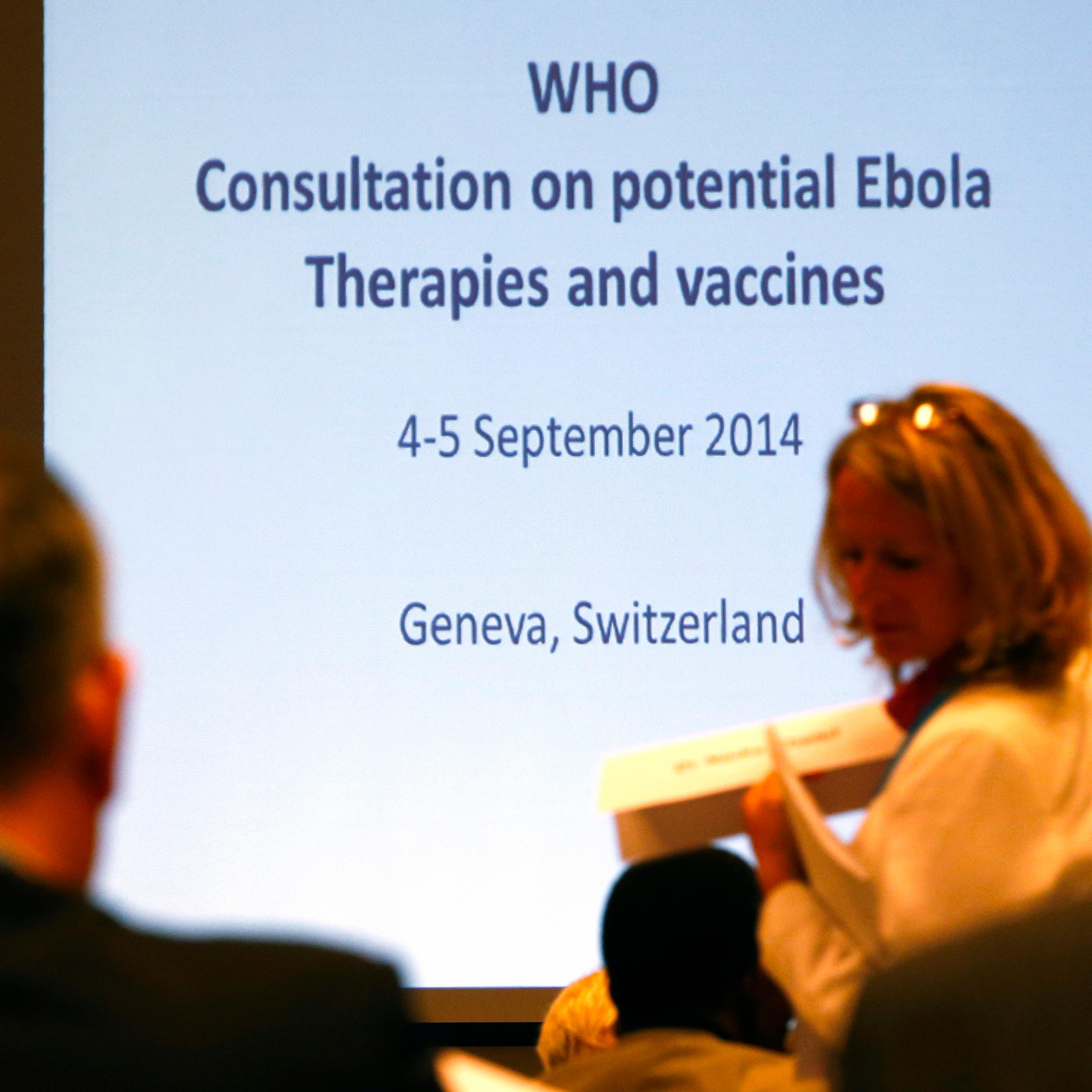 Participants arrive at the opening of a consultation of international experts on potential Ebola therapies and vaccines in Geneva