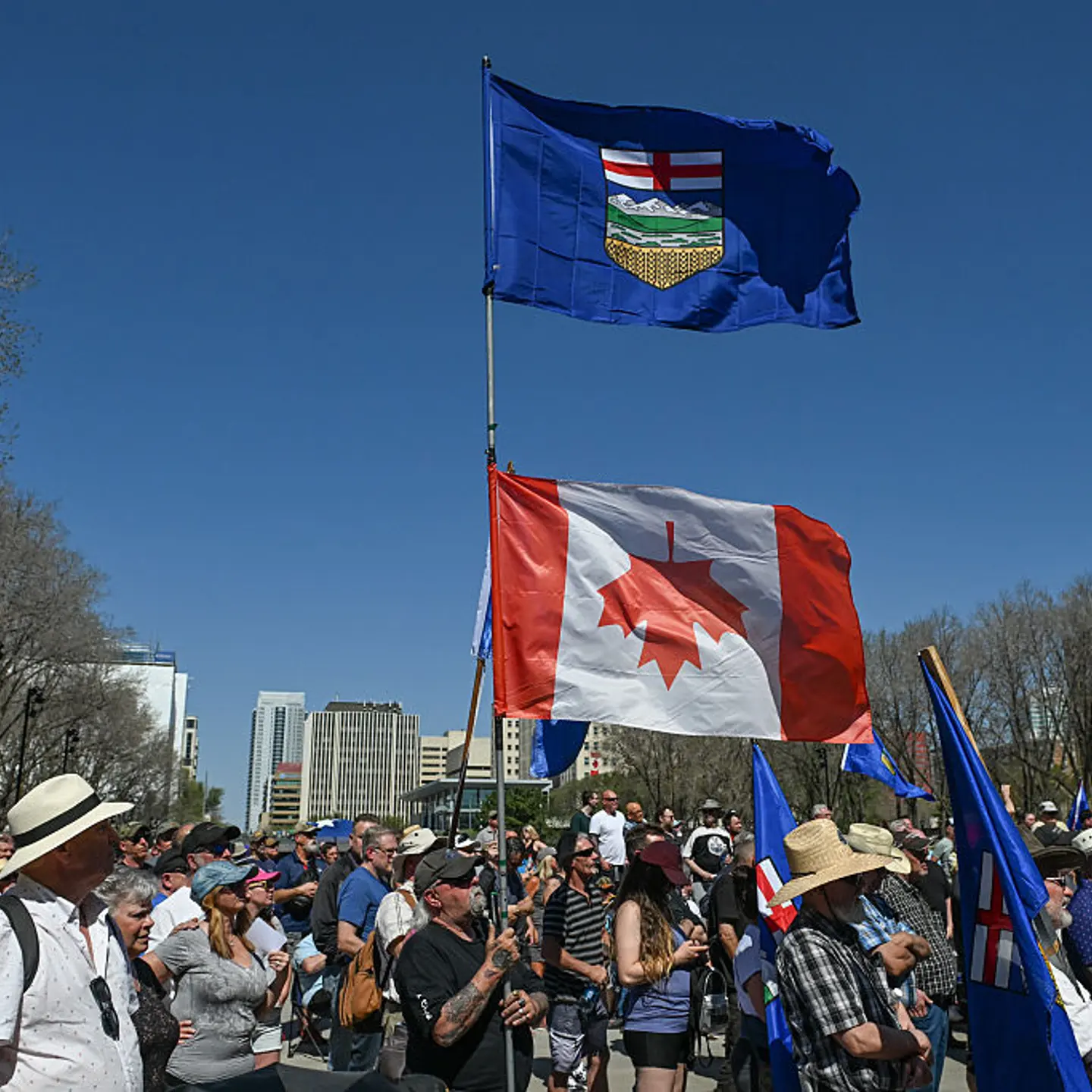 A participant holds an Alberta flag and an inverted Canadian flag as Alberta sovereigntists and supporters gather outside the Alberta Legislature for the Rally for Alberta Independence, following the federal election win by Prime Minister Mark Carney's L