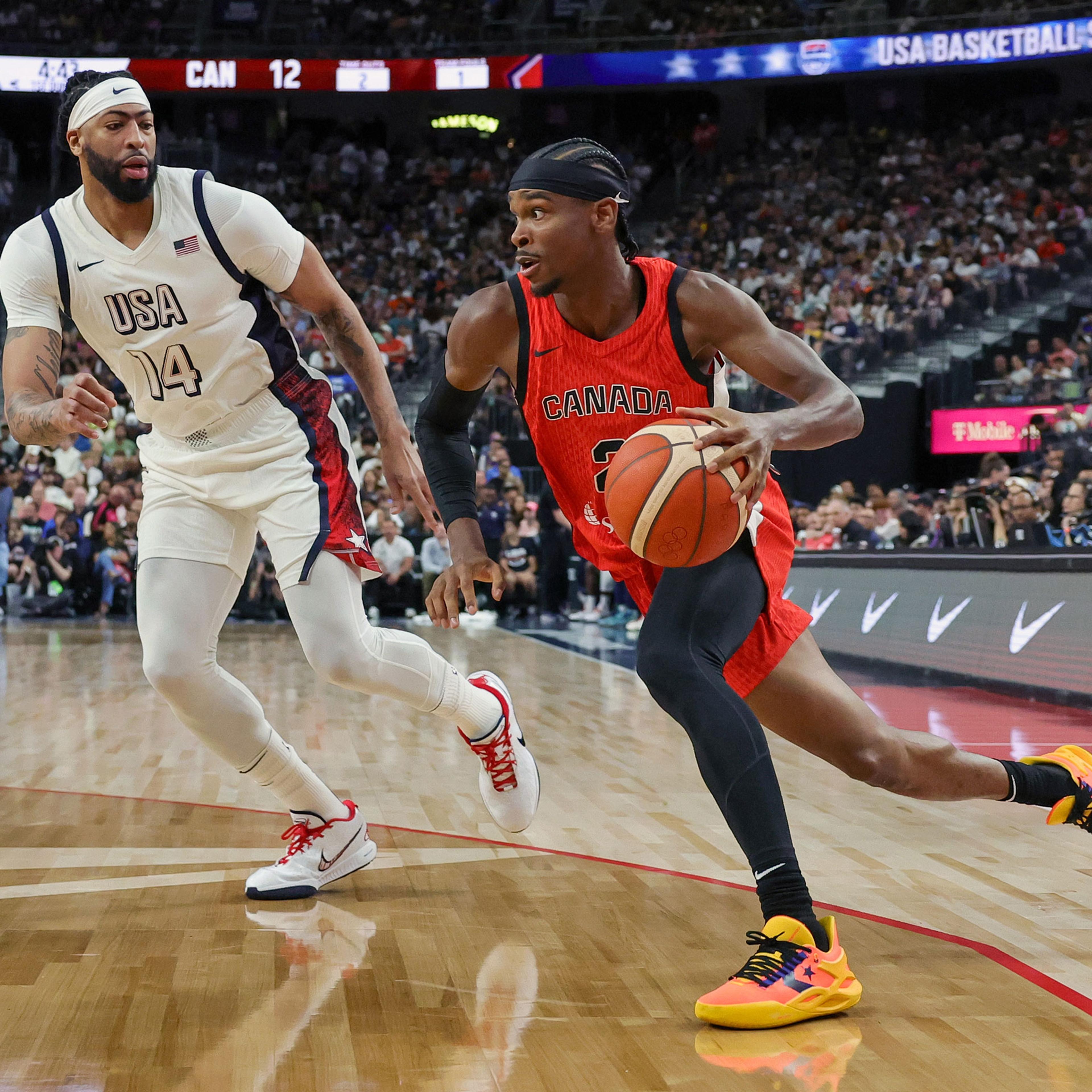 Canada star Shai Gilgeous-Alexander drives against Anthony Davis
