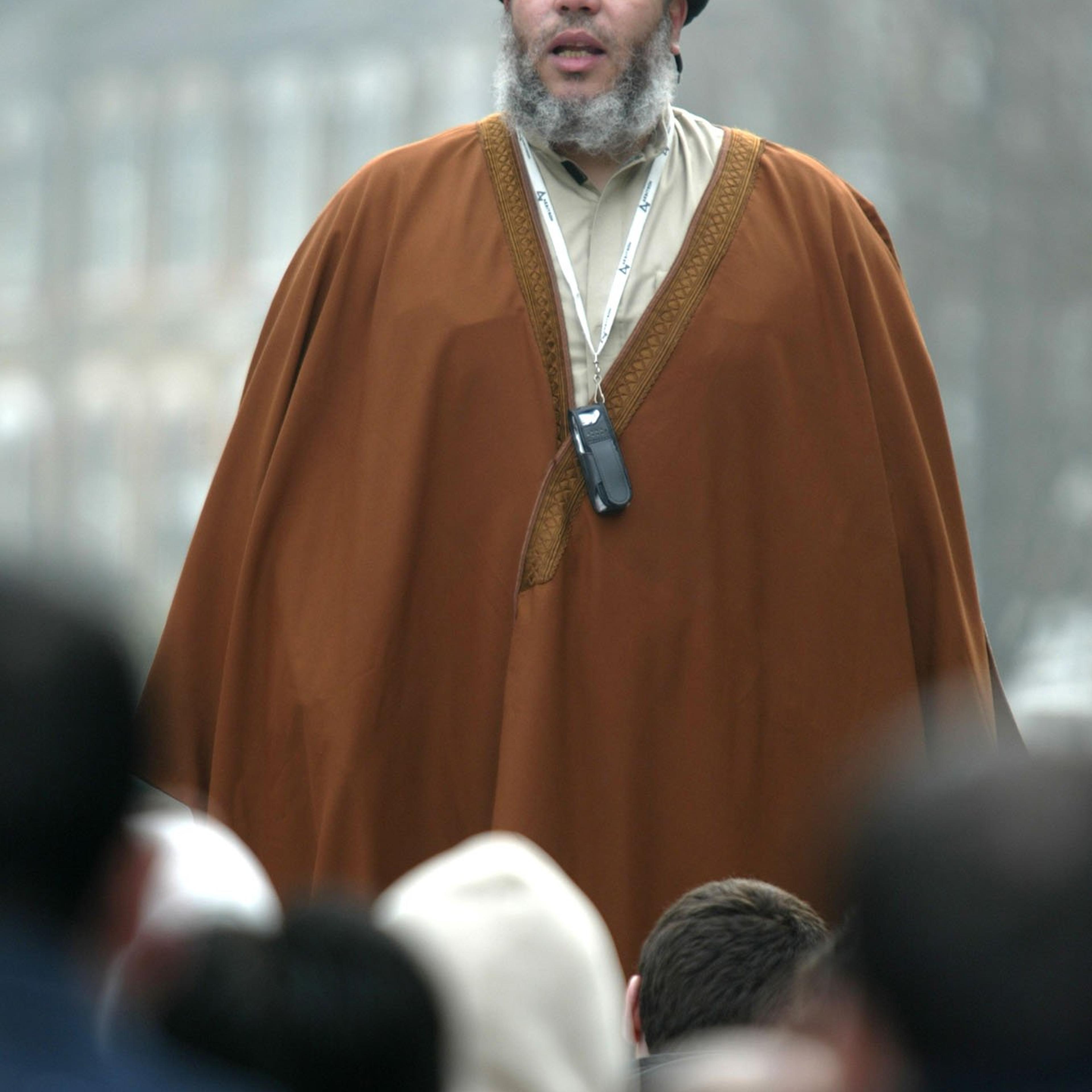 Muslim cleric Mustafa Kamel Mustafa prays in a street outside his Mosque in north London, on March 28, 2003.