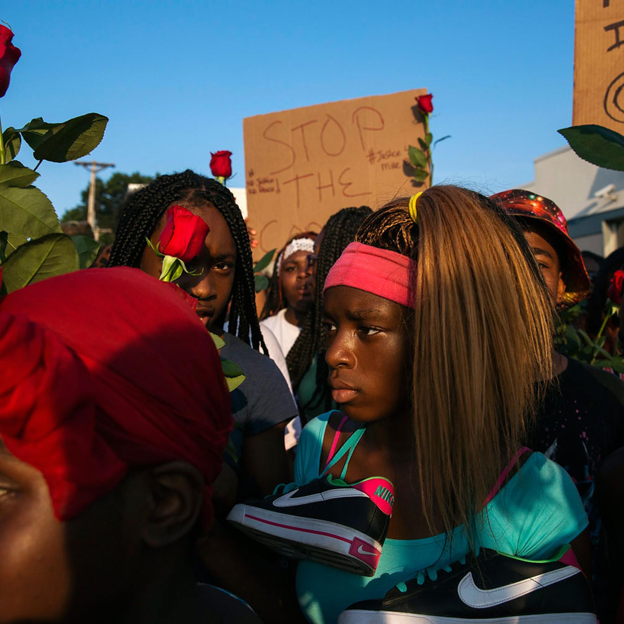 Demonstrators march down West Florissant during a peaceful march in reaction to the shooting of Michael Brown, near Ferguson, Missouri