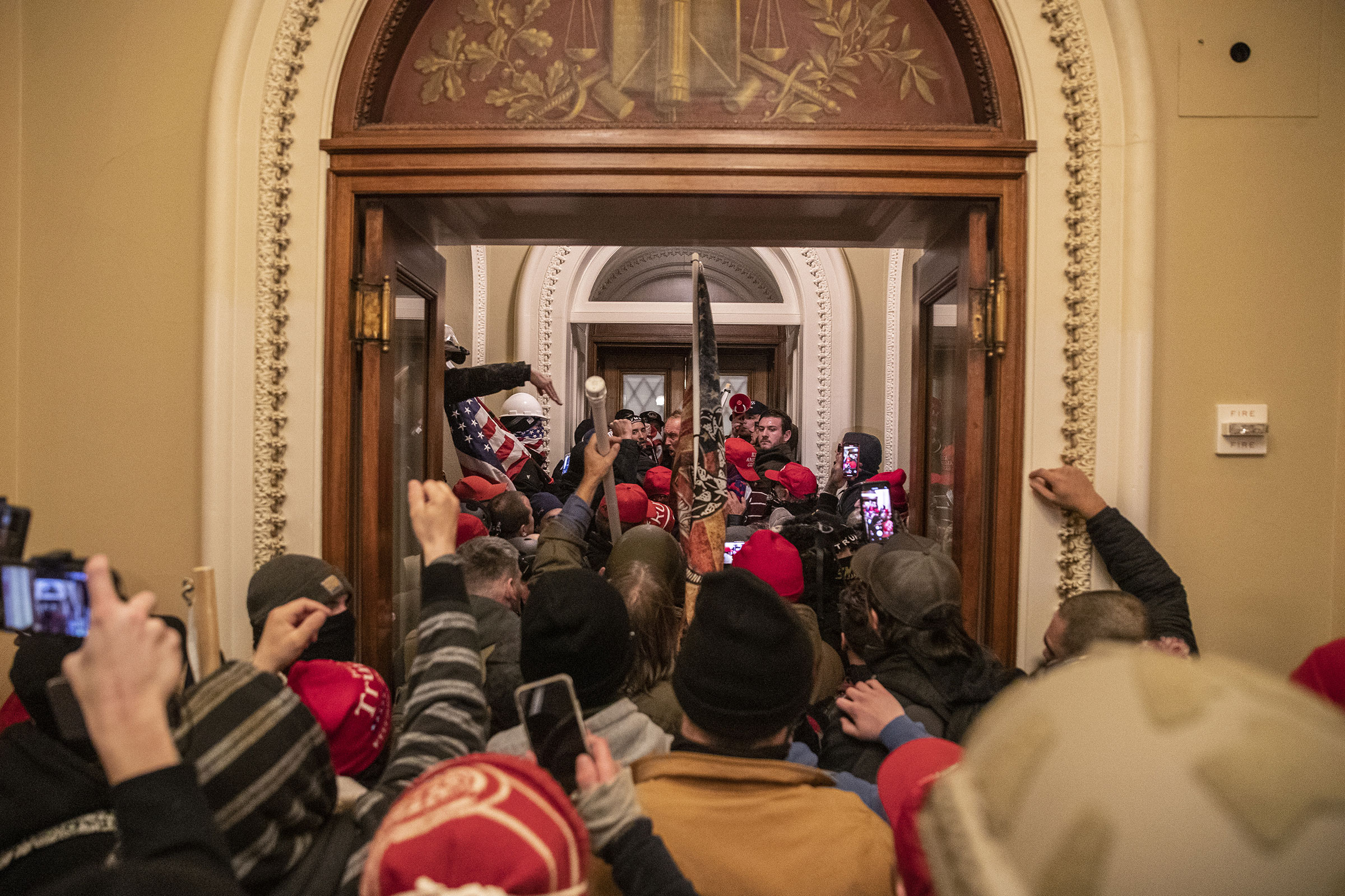Supporters of President Donald Trump walk through the Capitol after breaching barricades to the building on Jan. 6, 2021.