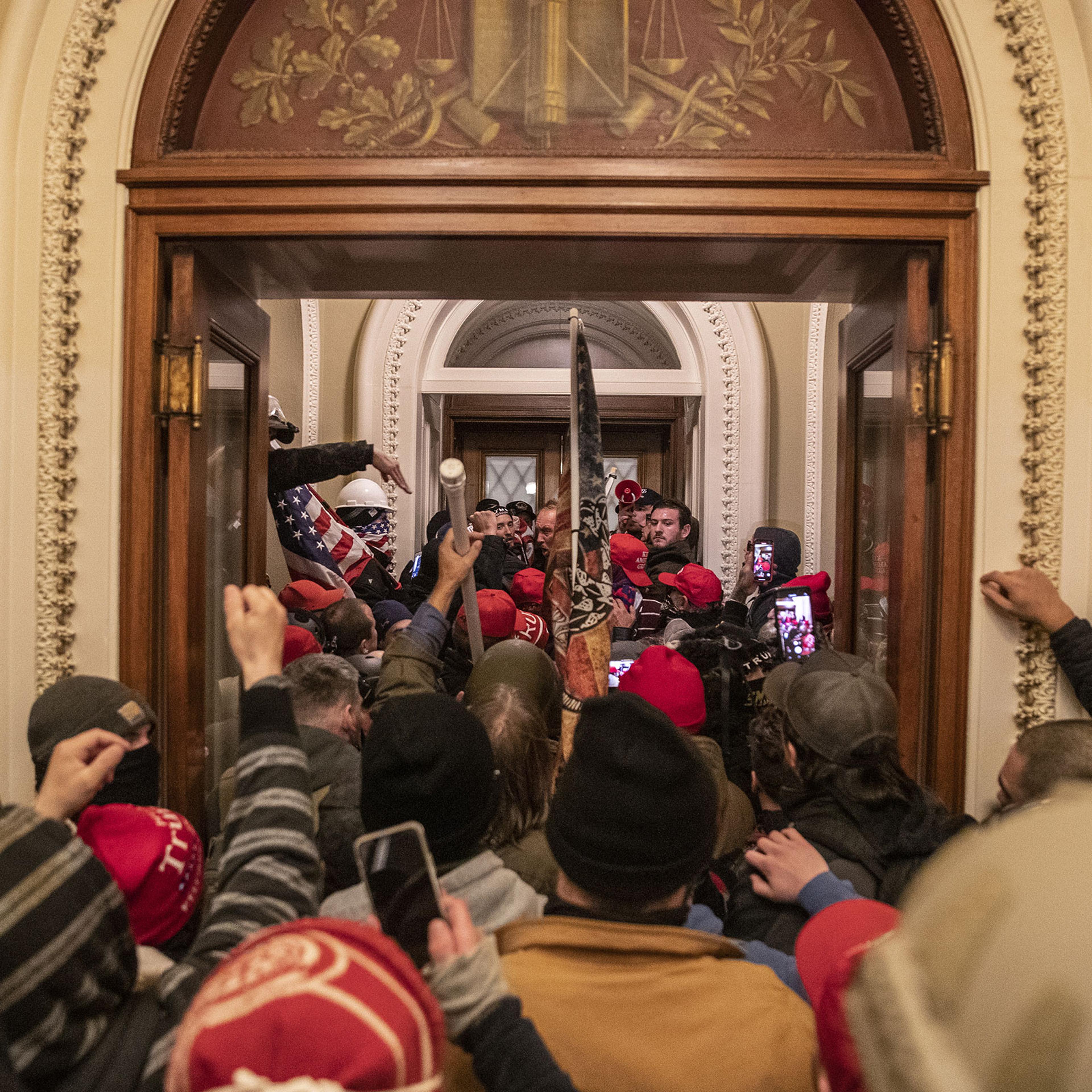 Supporters of President Donald Trump walk through the Capitol after breaching barricades to the building on Jan. 6, 2021.