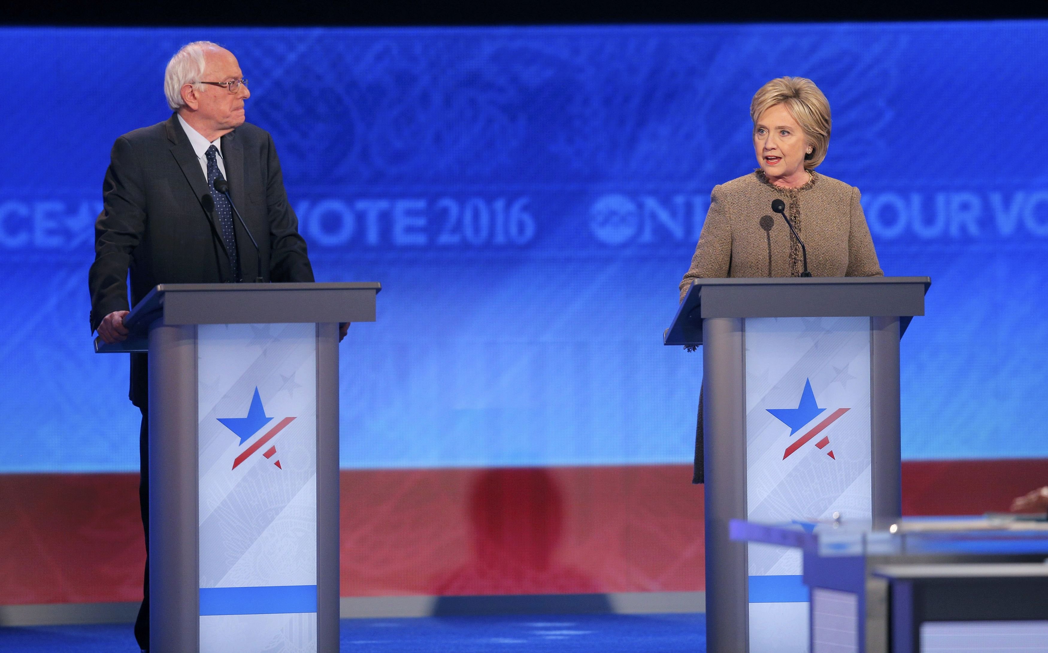 Democratic U.S. presidential candidate U.S. Senator Sanders listens to the opening statement of former Secretary of State Hillary Clinton at the Democratic presidential candidates debate at St. Anselm College in Manchester