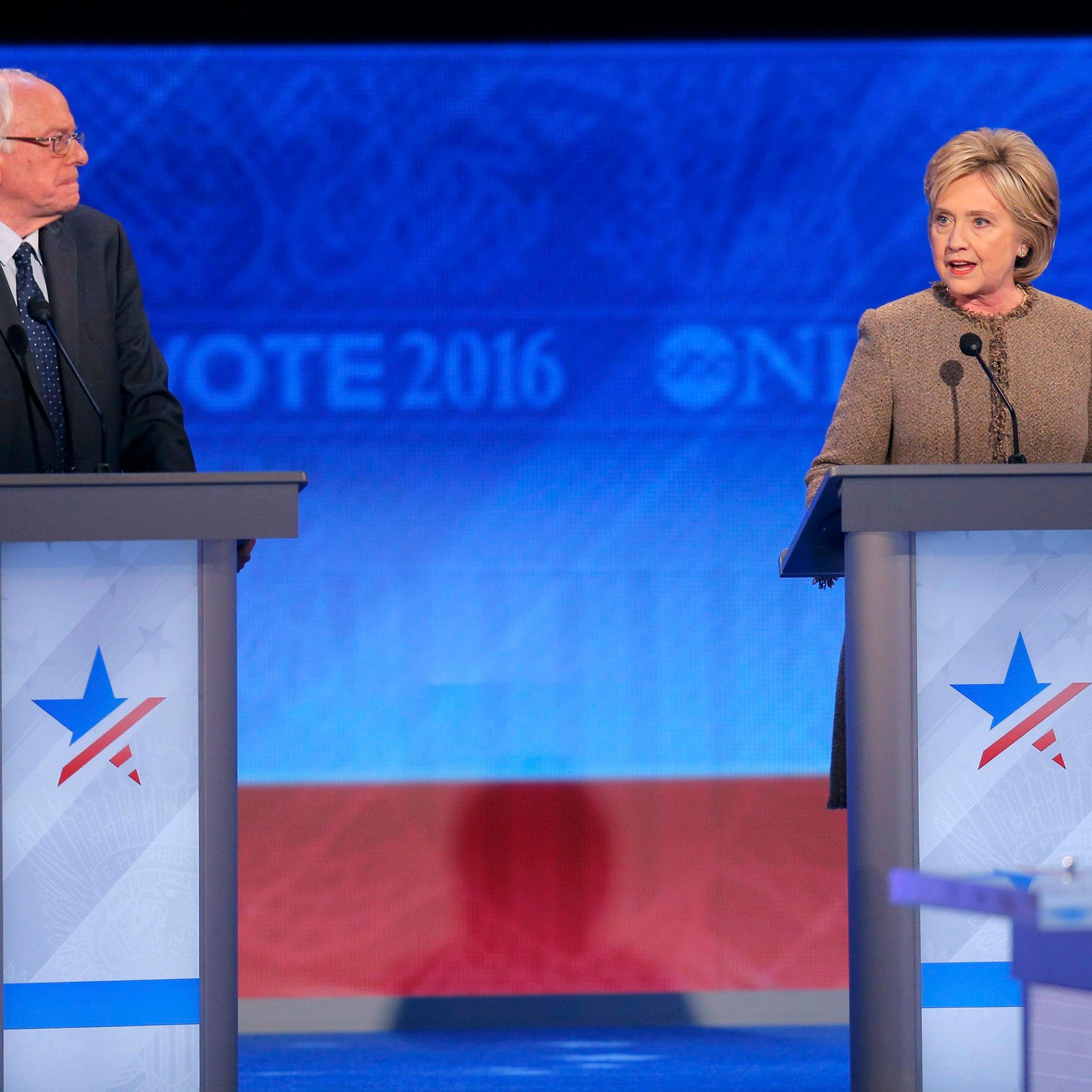 Democratic U.S. presidential candidate U.S. Senator Sanders listens to the opening statement of former Secretary of State Hillary Clinton at the Democratic presidential candidates debate at St. Anselm College in Manchester