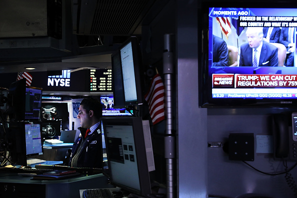 A television screen shows President Donald Trump as traders work on the floor of the New York Stock Exchange (NYSE) on the first day of trading after Donald Trump was sworn in as president on January 23, 2017 in New York City.