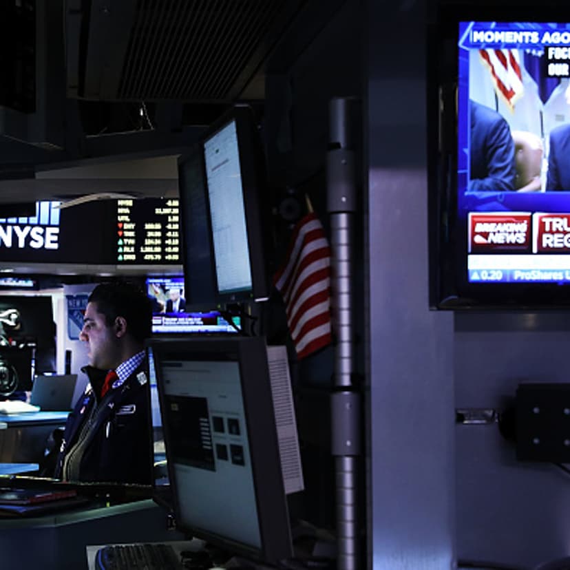 A television screen shows President Donald Trump as traders work on the floor of the New York Stock Exchange (NYSE) on the first day of trading after Donald Trump was sworn in as president on January 23, 2017 in New York City.