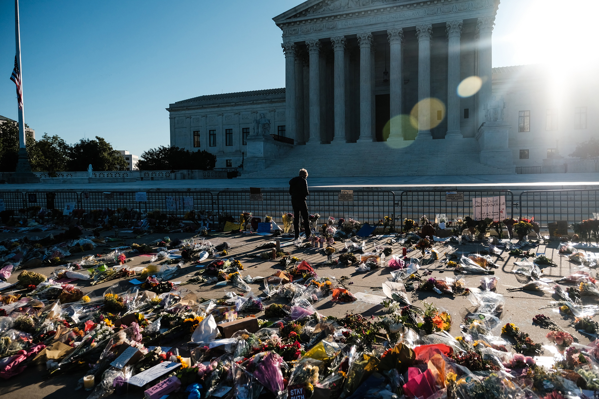 A mourner pays their respects at a makeshift memorial outside the Supreme Court building in Washington, on Sept. 20