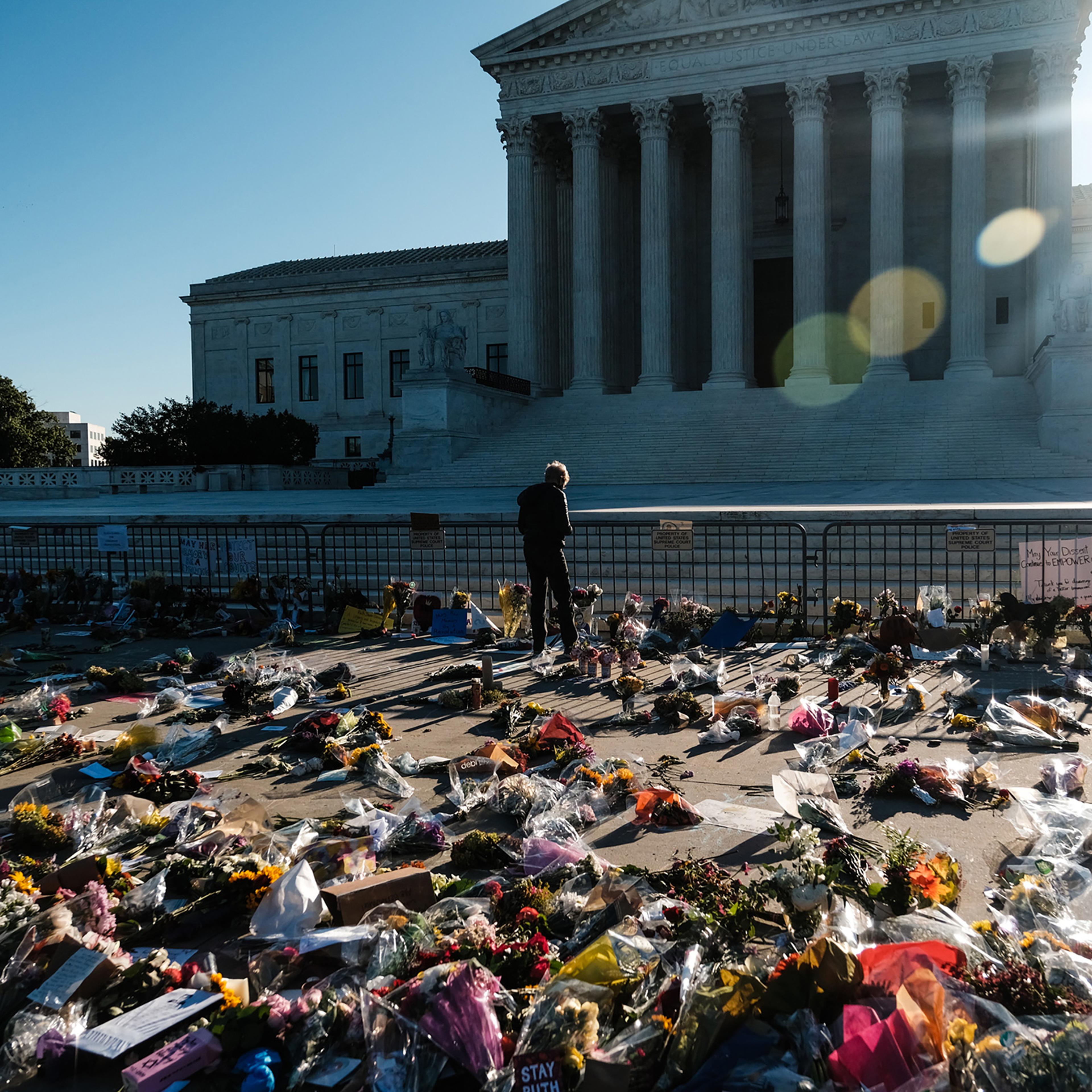 A mourner pays their respects at a makeshift memorial outside the Supreme Court building in Washington, on Sept. 20