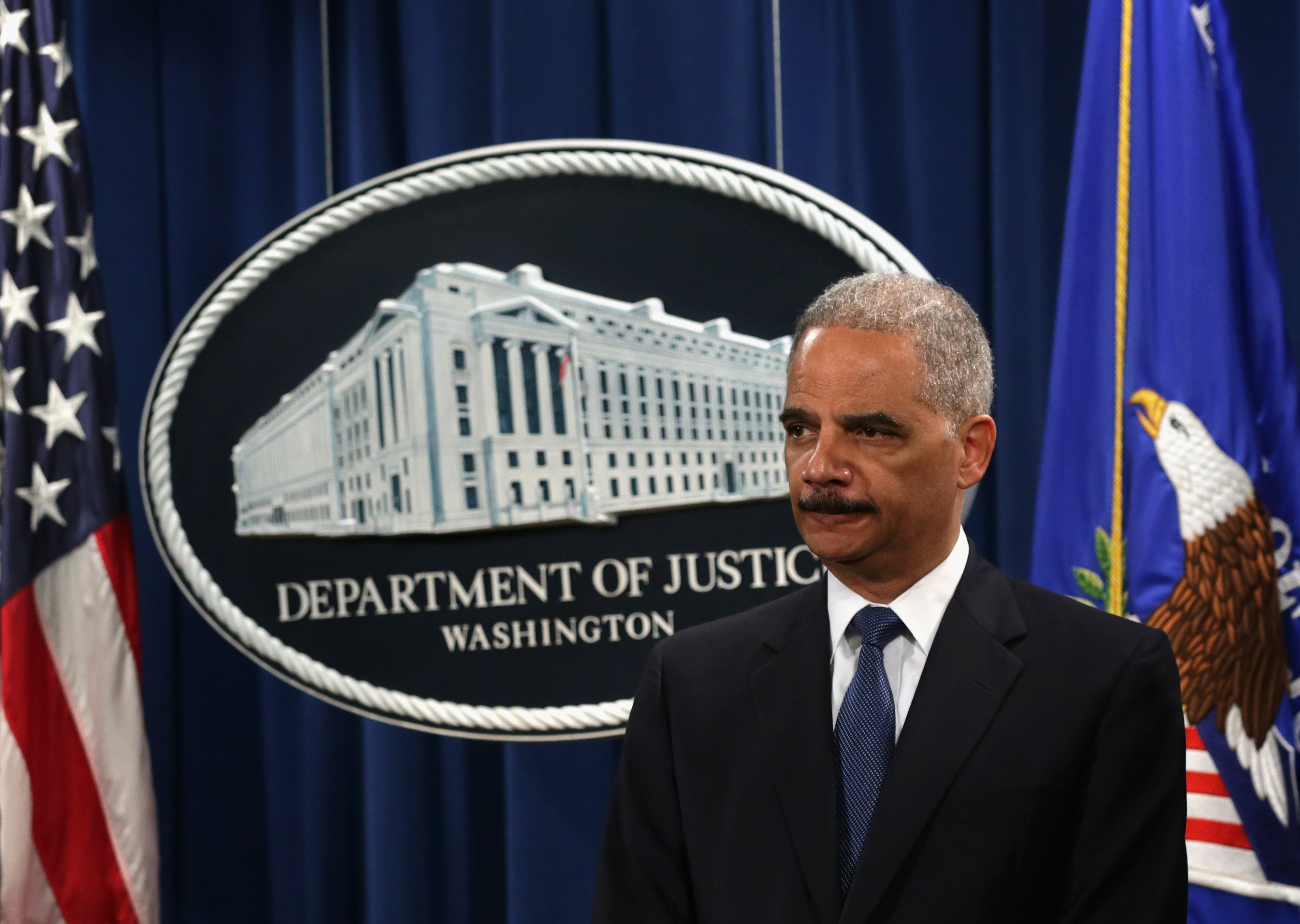 Attorney General Eric Holder listens during a news conference to announce indictments against Chinese military hackers on cyber-espionage May 19, 2014 at the Department of Justice in Washington, DC.